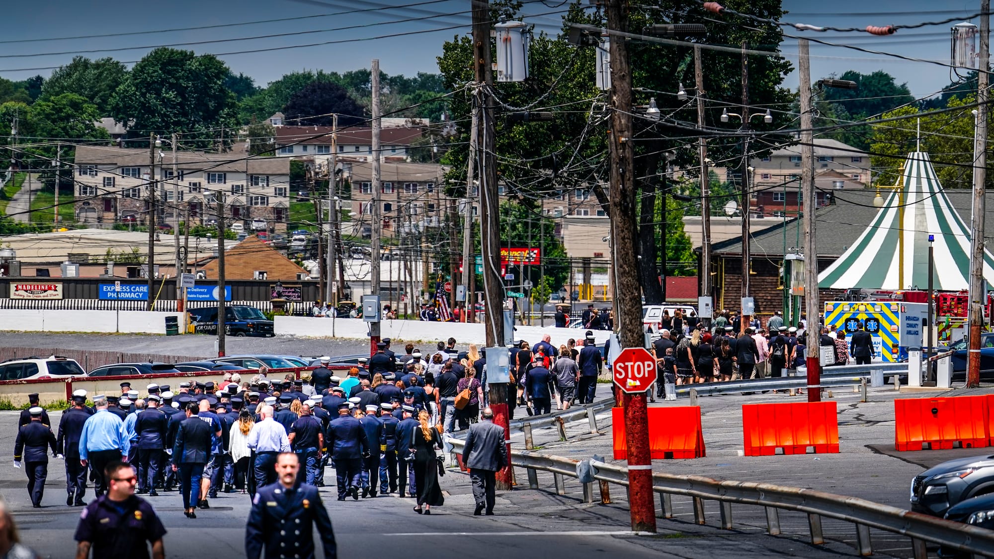 Mourners walk to the Main Gate after services. A Mass of Christian Burial was held at the Cathedral of S. Catharine of Siena 