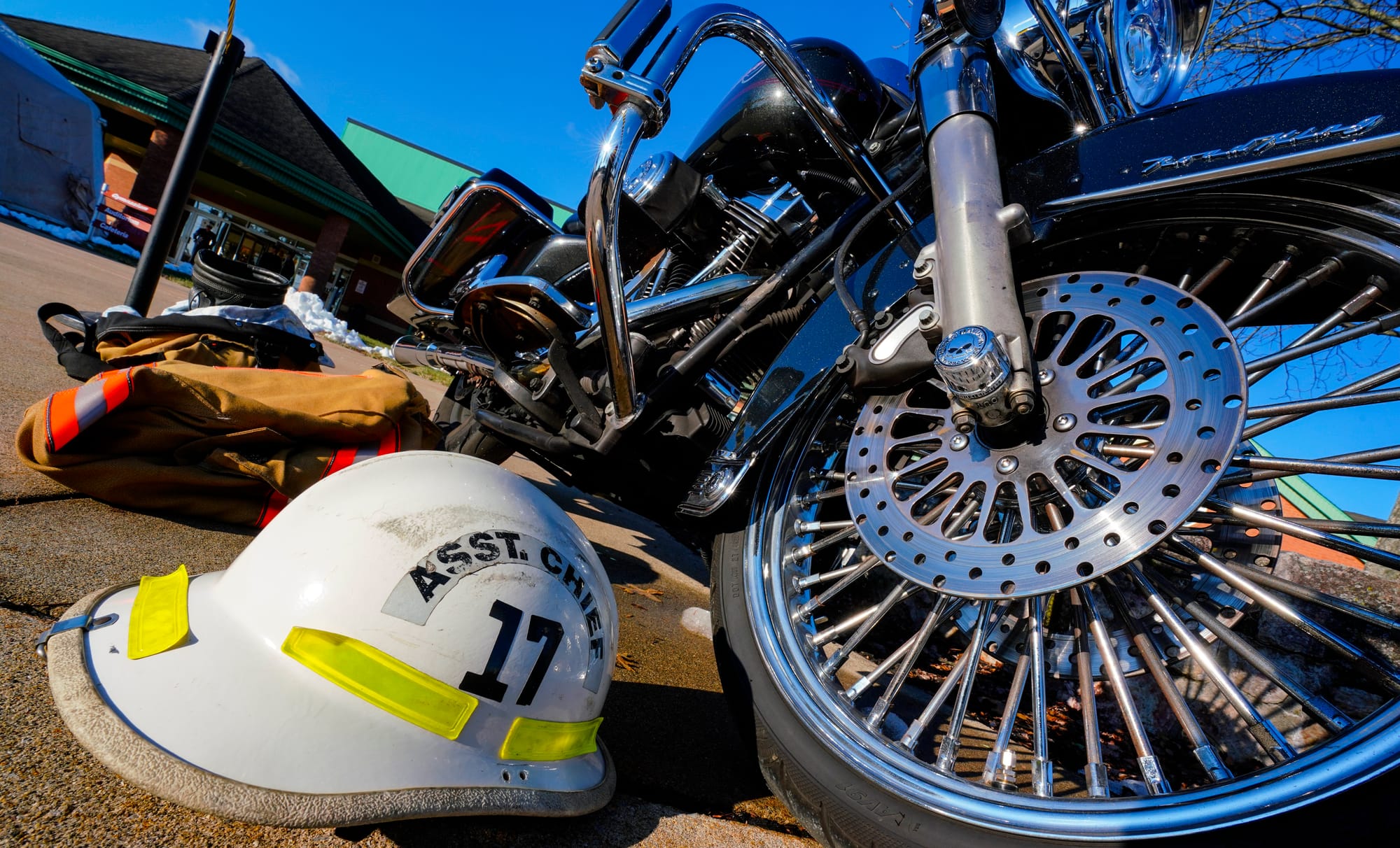 The motorcycle and helmet of Zachary Paris are placed in front of Northwestern Lehigh Middle School. Mourners gather at North