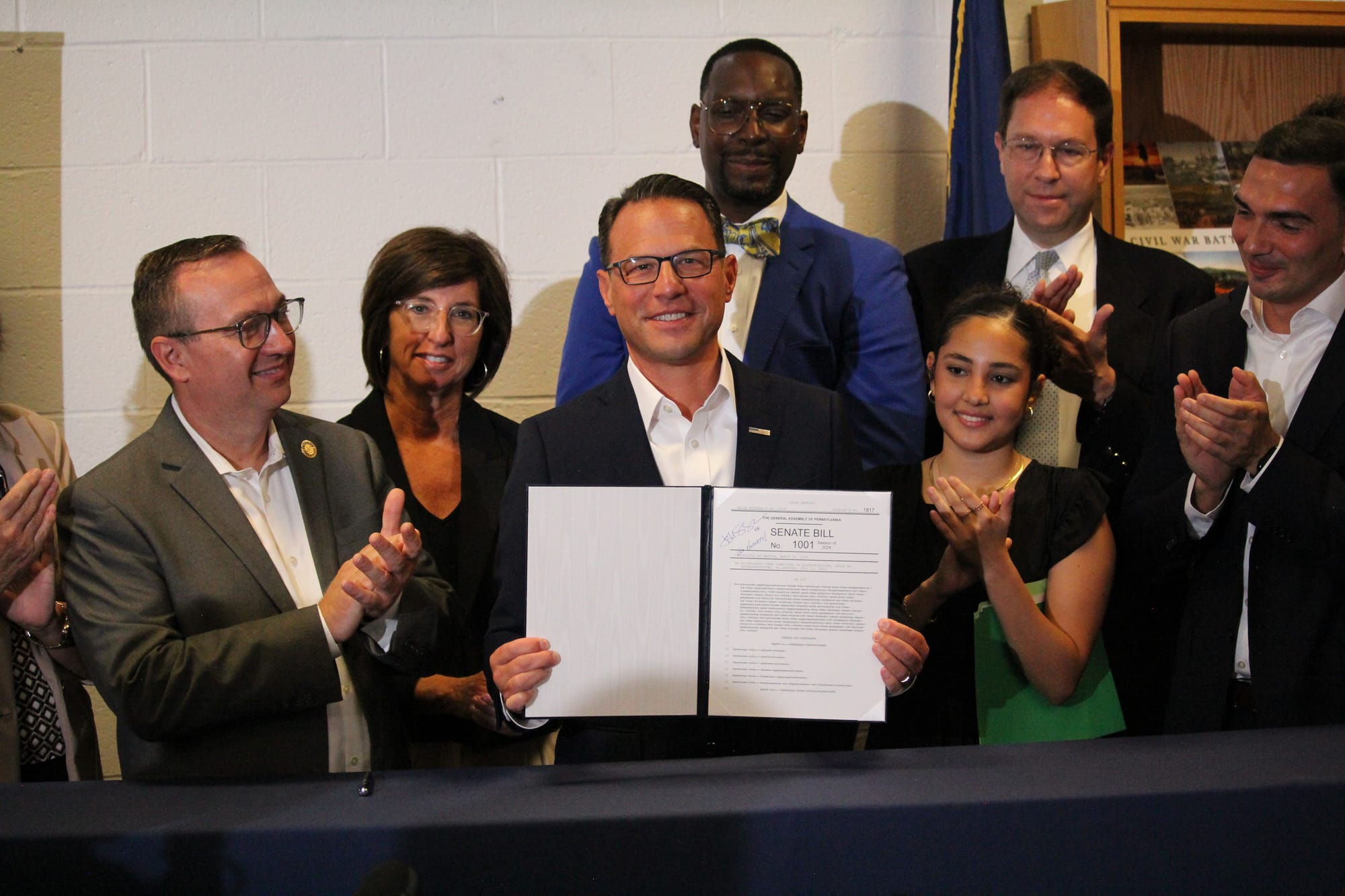 Governor Josh Shapiro holding the ceremonially signed budget bill Thursday.