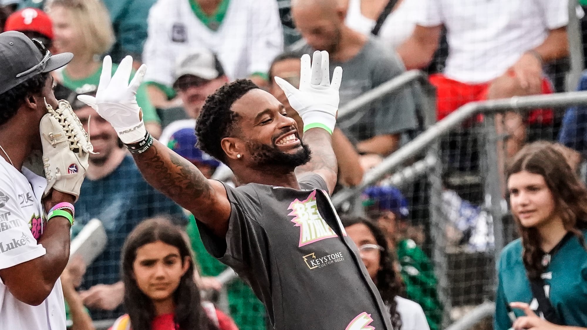 Darius Slay reaches first base. The annual DeVonta Smith Celebrity Softball Game featuring Philadelphia Eagles and other athl