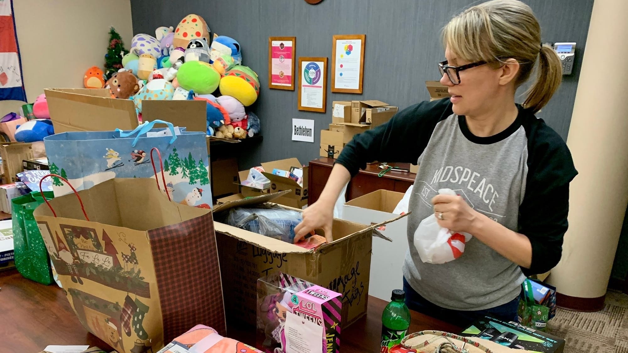 KidsPeace Director of Development Missy Hartney unpacks donated toys for the Angel Tree holiday gift drive.