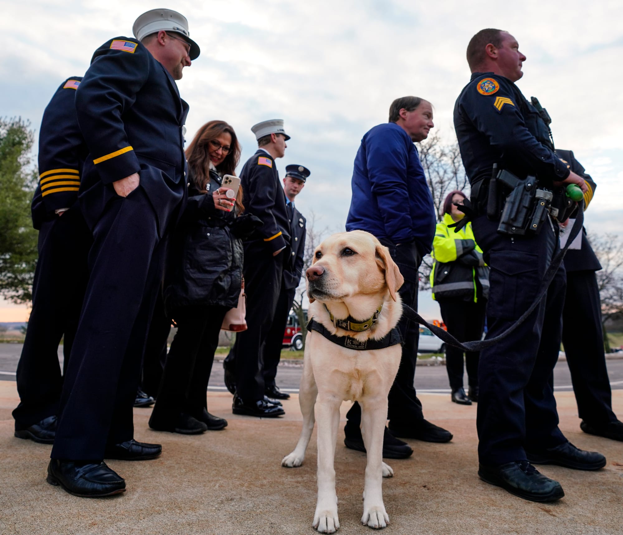 Silver, the Bethlehem City arson dog, waits to enter the school. Mourners gather at Northwestern Lehigh Middle School in New 