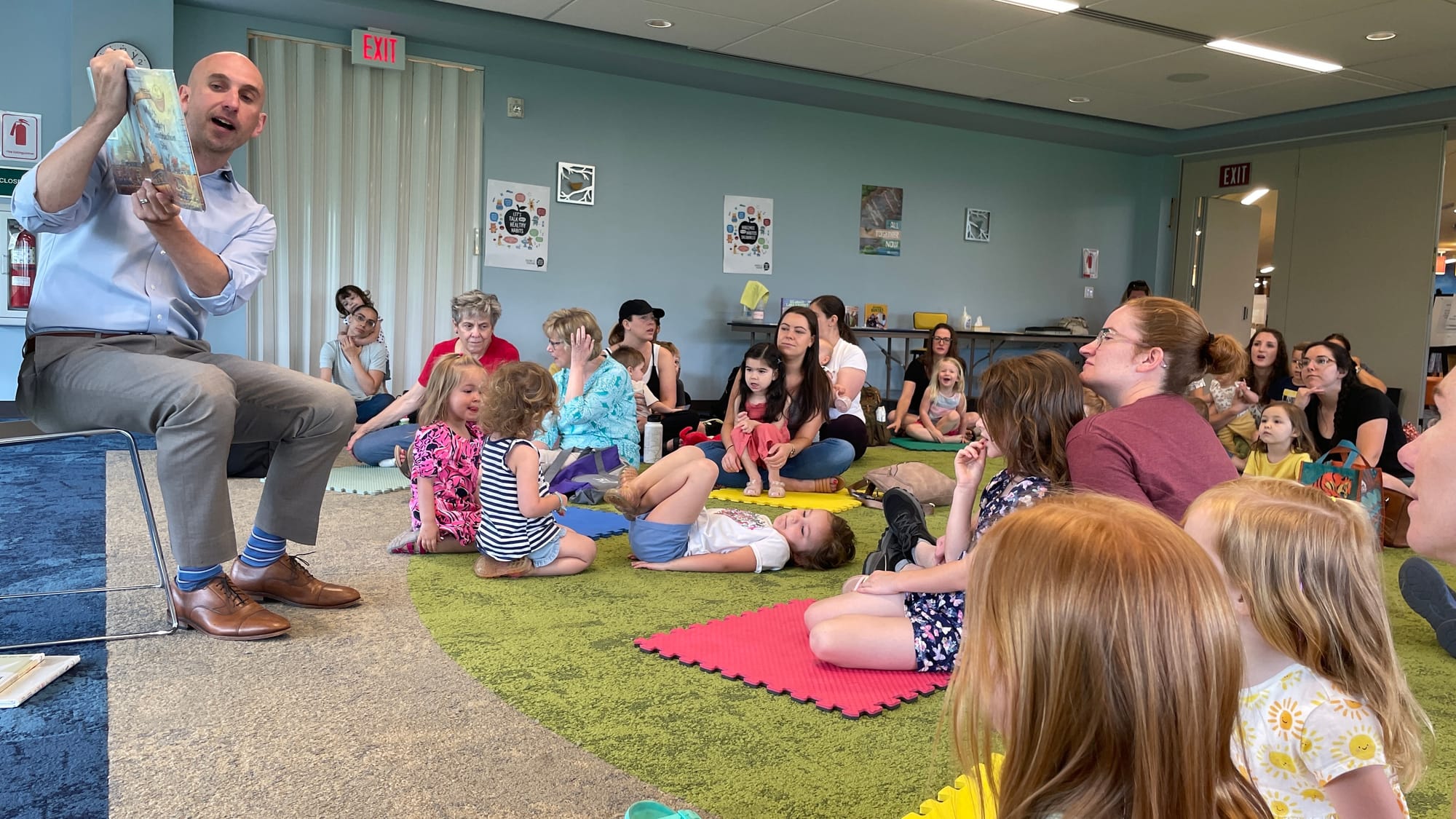 Bethlehem Mayor J. William Reynolds cracks open a book with the kids at the city's public library on Monday, June 12, 2023.