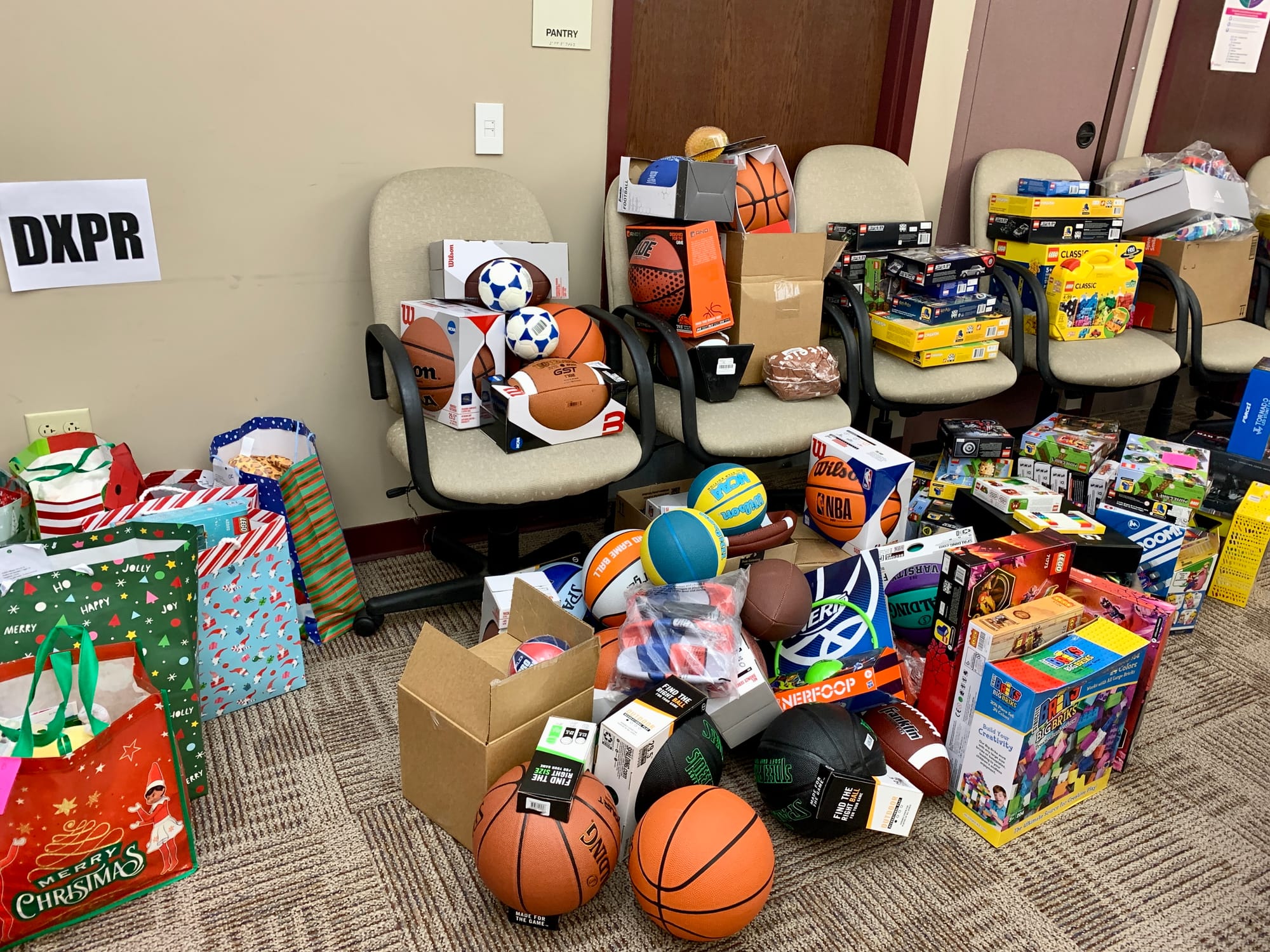 Gifts piled up on desk chairs in a KidsPeace conference room.