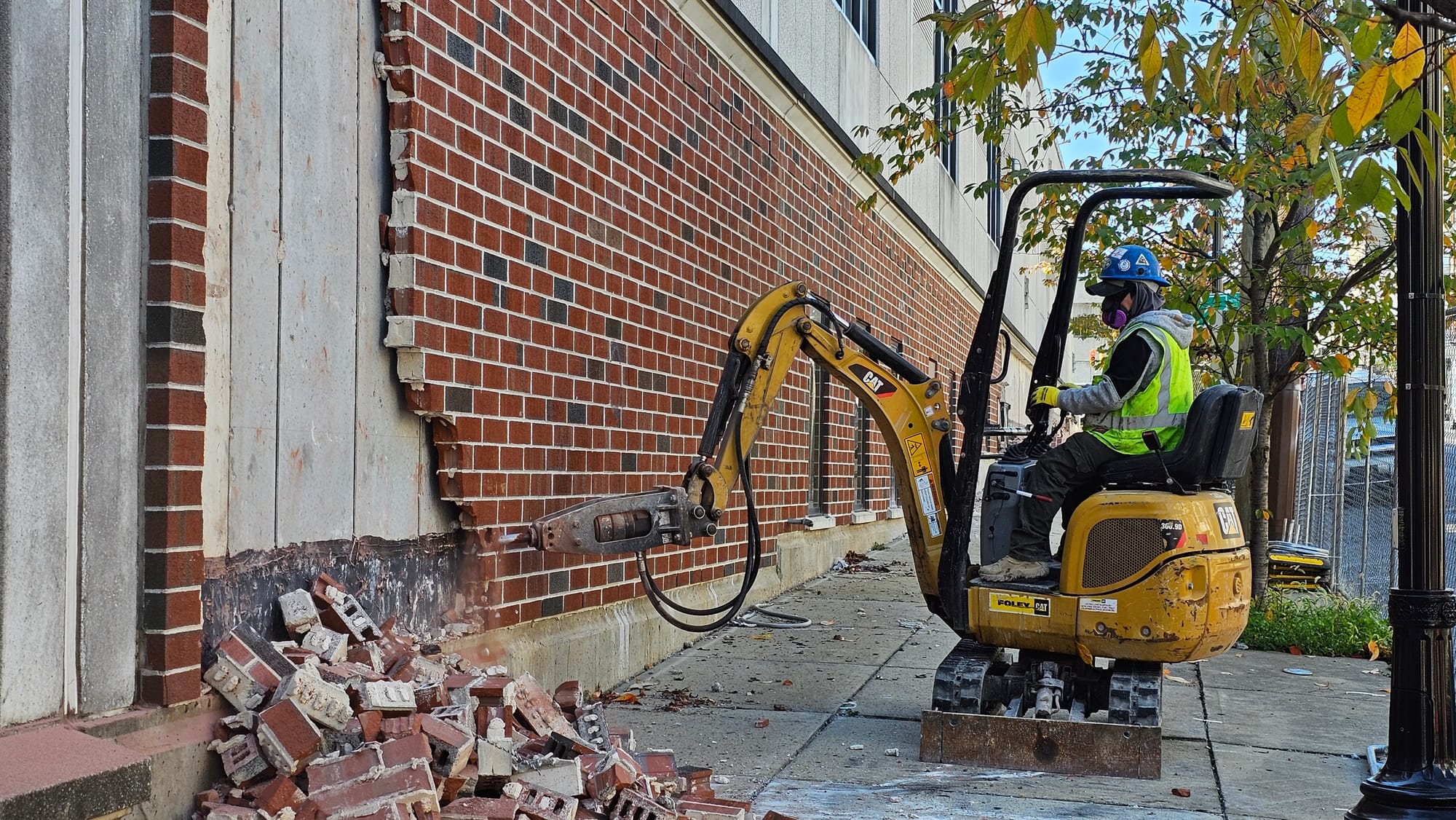 A worker takes down one of the walls brick by brick at The Morning Call's old headquarters Tuesday, Oct. 24.