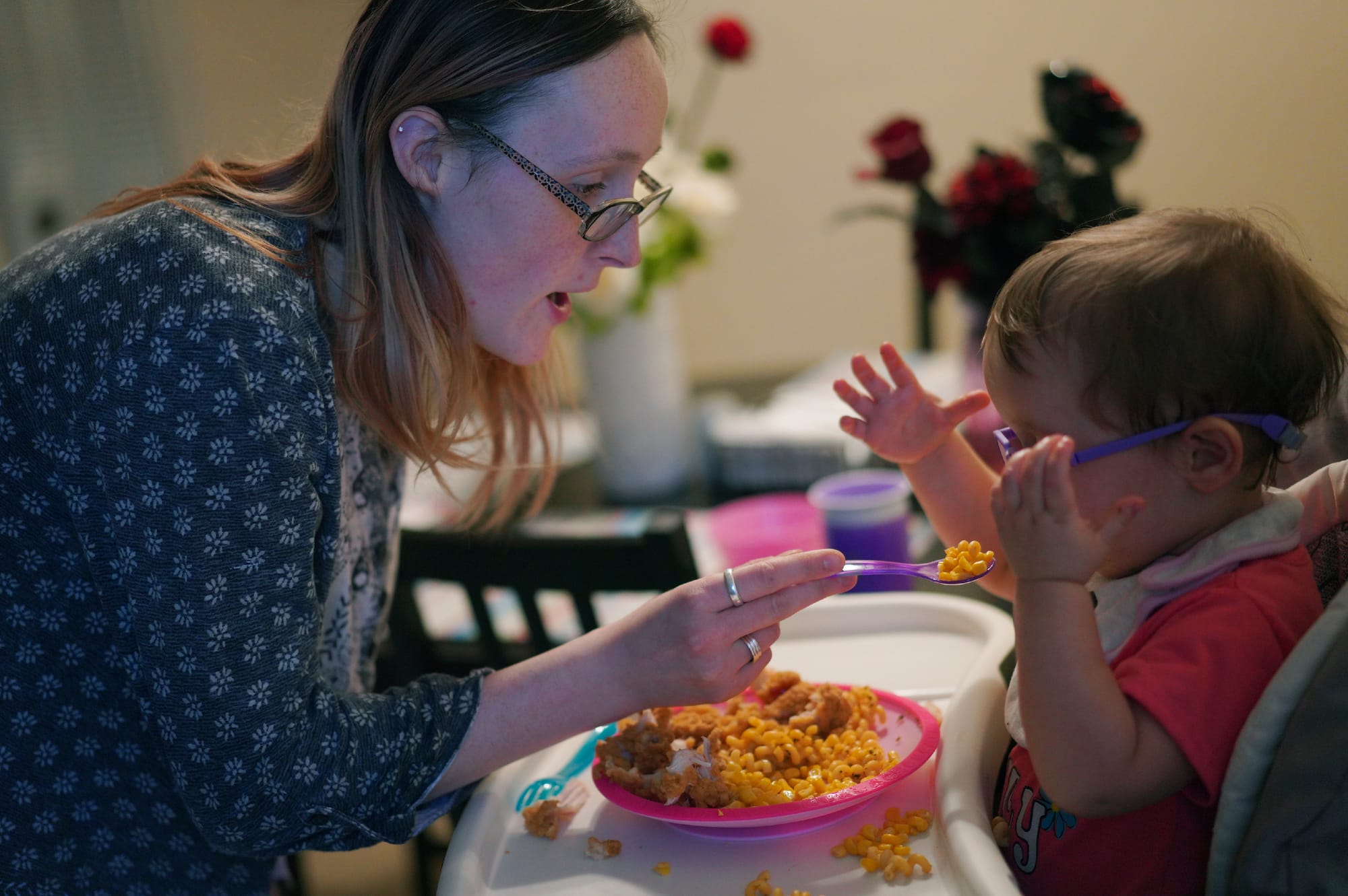 Lauren Hackney feeds her 1-year-old daughter chicken and macaroni during a supervised visit at their apartment in Oakdale, Pa