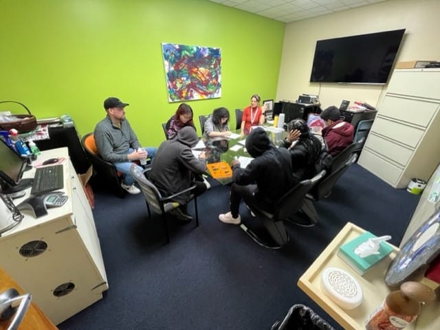 A group of seniors from Building 21 make plans to paint on the doors at Sixth Street Shelter in Allentown.
