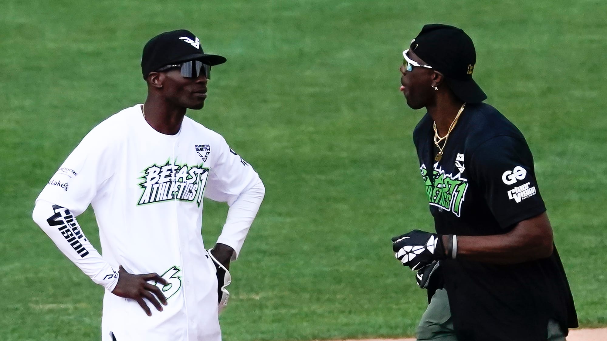 Terrell Owens, right, sticks out his tongue at Chad Ochocinco as he rounds the bases on a home run. The 2nd annual DeVonta Sm