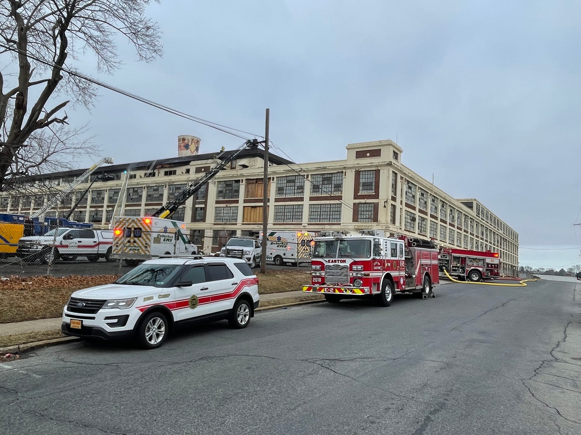 Firefighters respond to the old Dixie Cup factory after a fire broke out Friday morning in the structure.