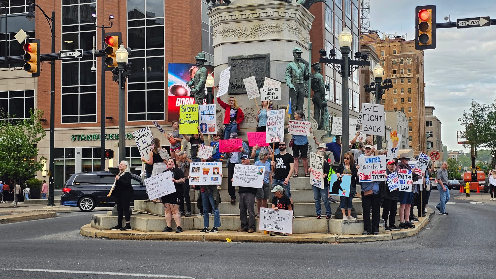 Protesters rally on the Soldiers and Sailors monument at the end of a May Day demonstration in downtown Allentown on Thursday