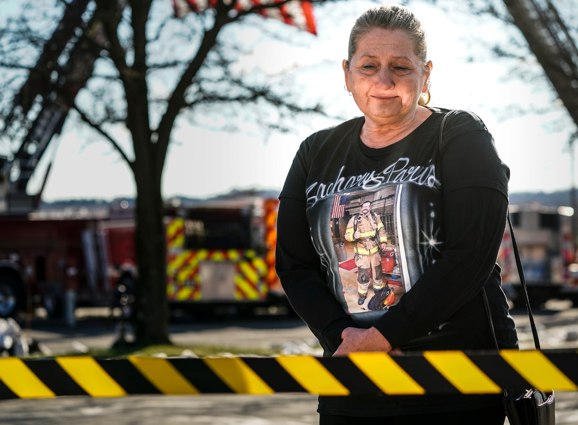 Carol Paris, mother of fallen New Tripoli firefighter Zachary Paris, looks at a display of her late son's things including hi