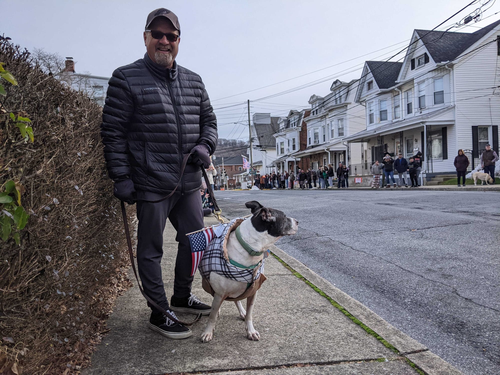 Joel Diefenderfer and his pup Frank were some of many in the growing crowd given small American flags to wave by other onlook