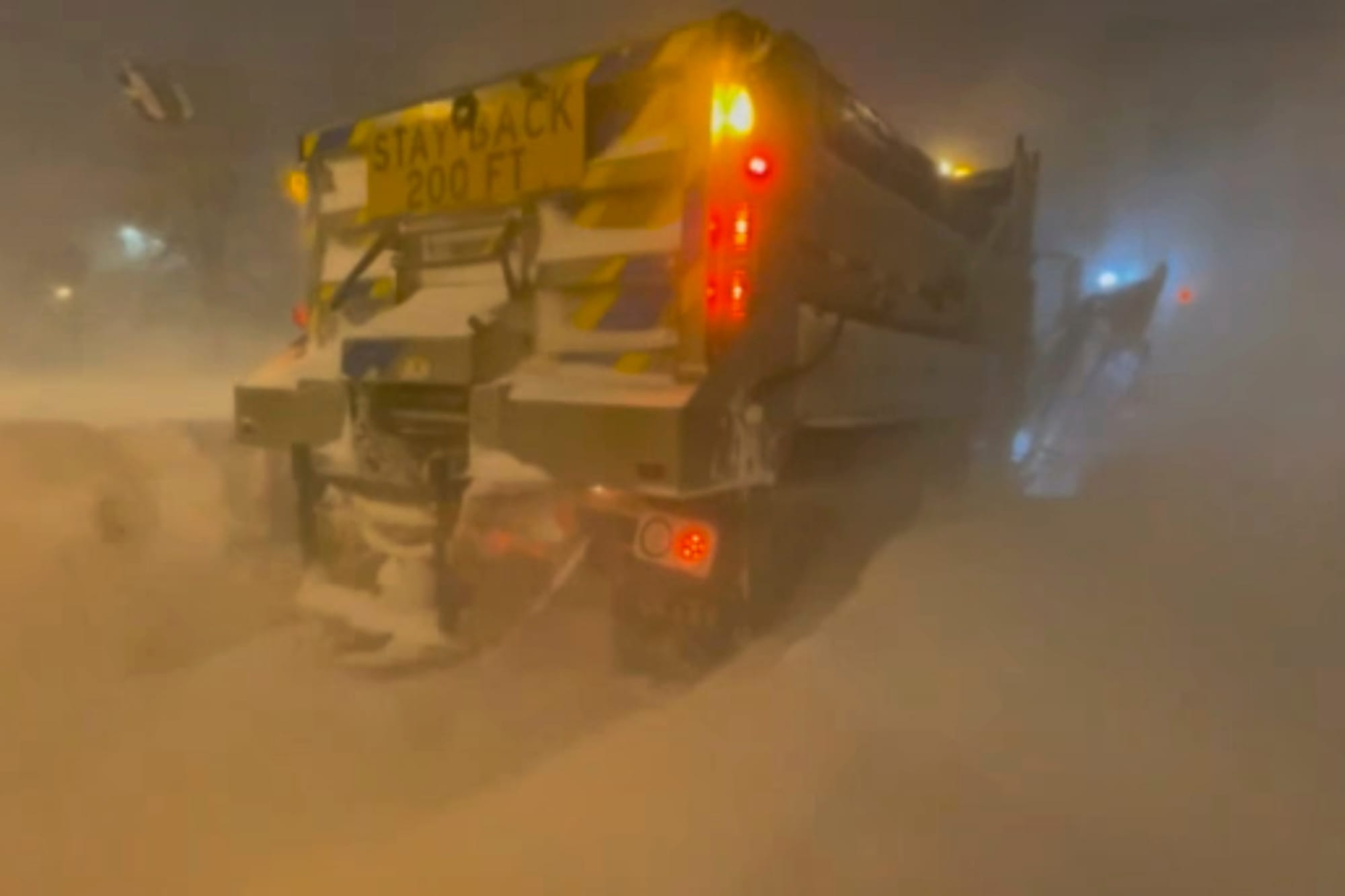 High winds and snow covers the streets and vehicles in Buffalo, N.Y. early Sunday, Dec. 25, 2022. Millions of people hunkered
