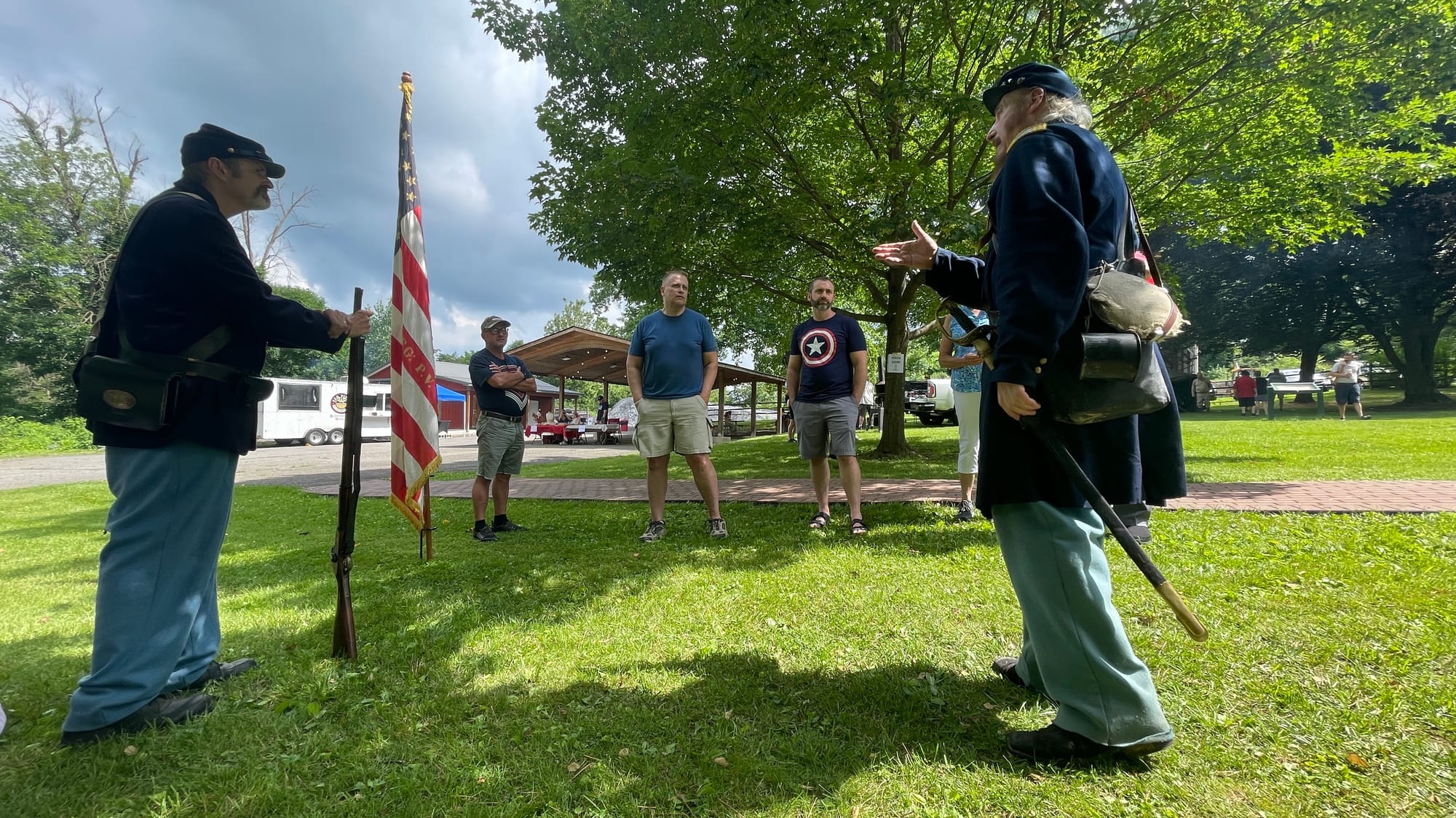 Rick Eisenhart (right), representing the 153rd Pennsylvania Volunteer Infantry, speaks on the Civil War with a small group of
