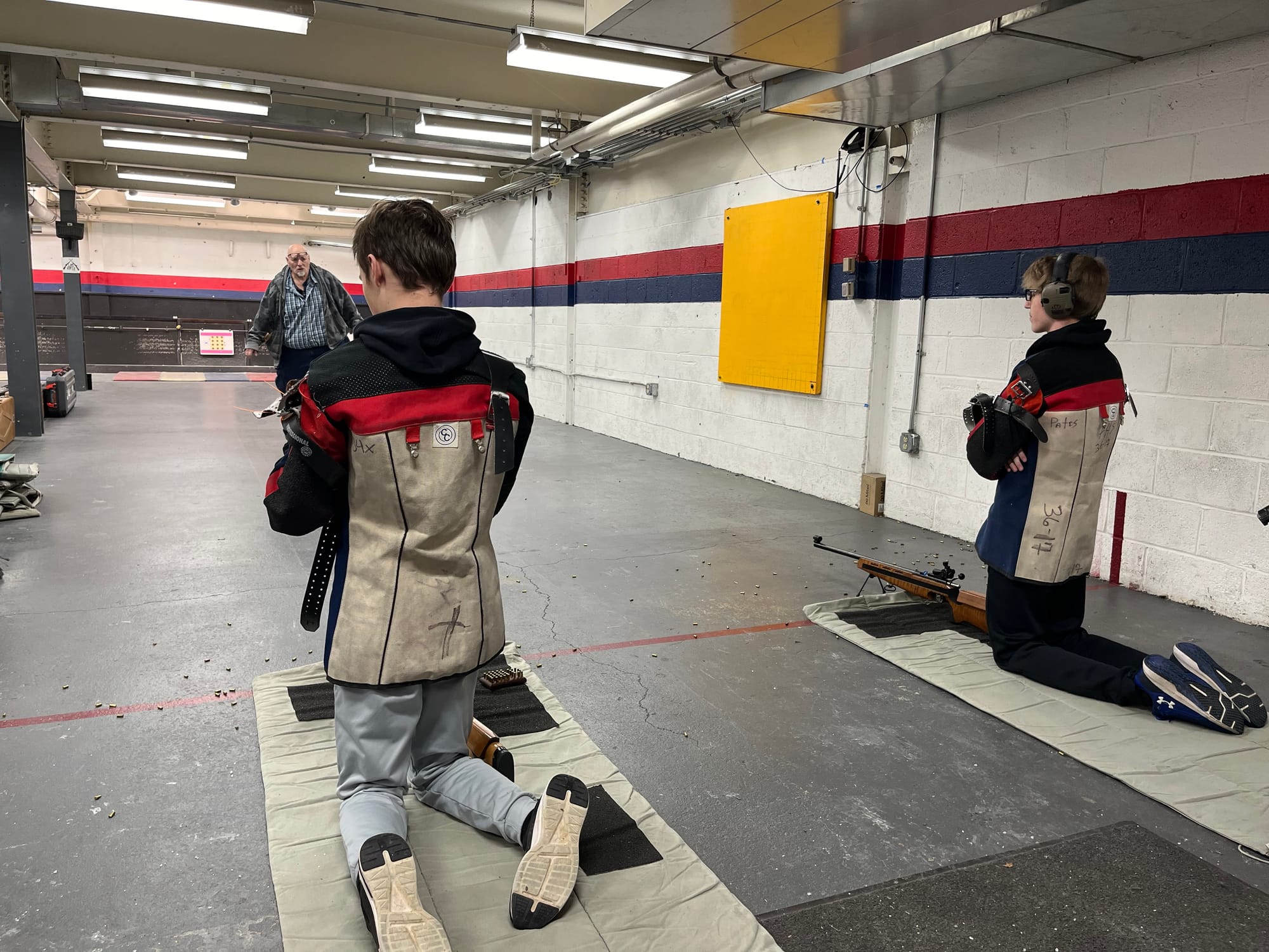 Freedom High School's Kaden Fredrickson, left, and Gage Landis wait for coach Paul Dorney (foreground) to return from hanging