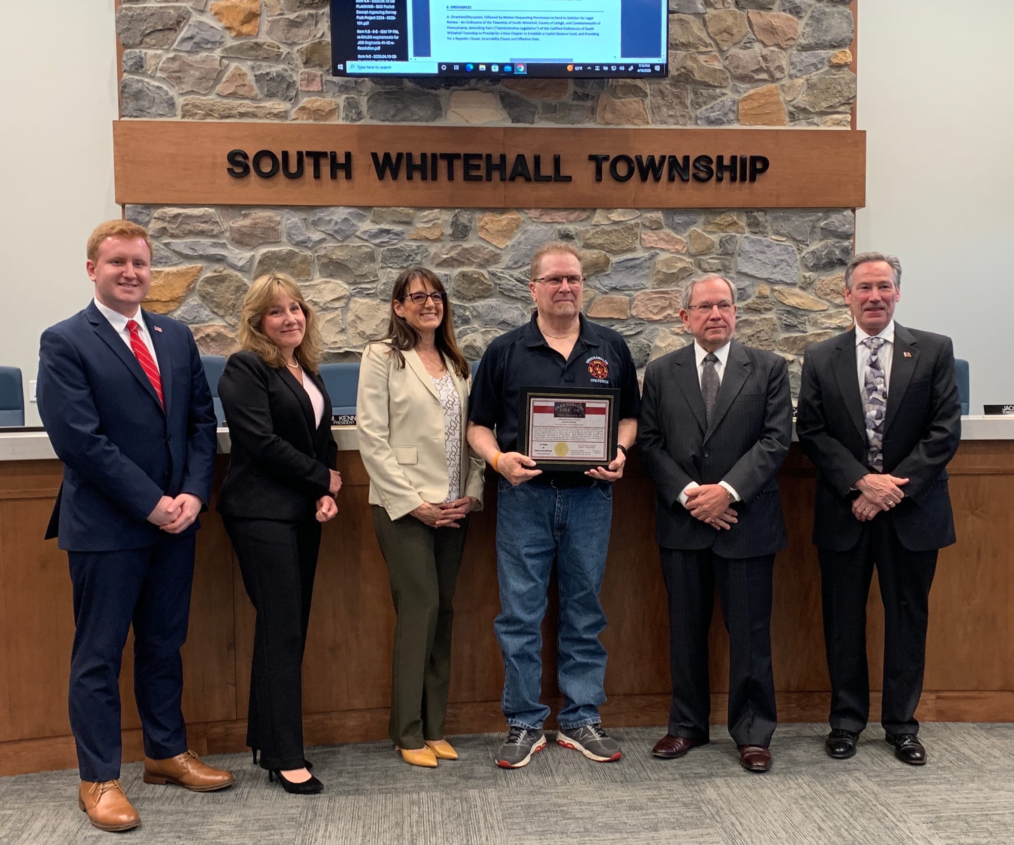 George Sverha of Greenawalds Fire Company receives a Distinguished Service Award from township commissioners.