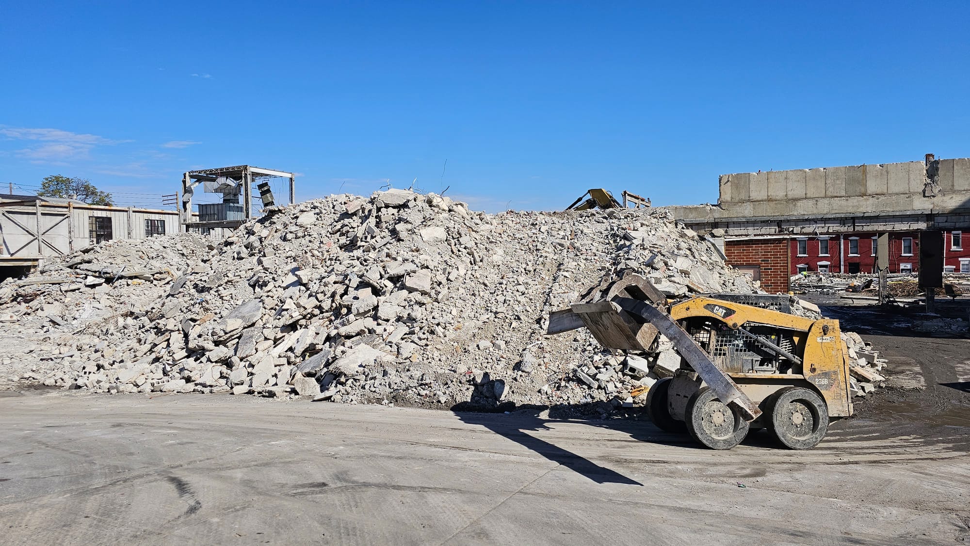 A bulldozer carries a twisted beam through the demolition site at the former Morning Call building Tuesday, Oct. 24.