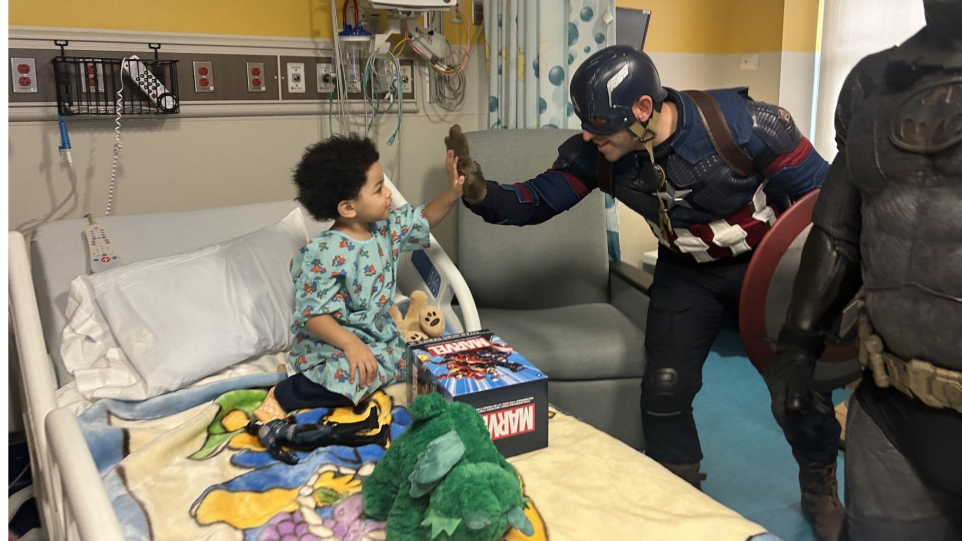 Emilio Gomez, 3, gets a visit from a group of firefighters dressed as superheroes at St. Luke's University Health Network.
