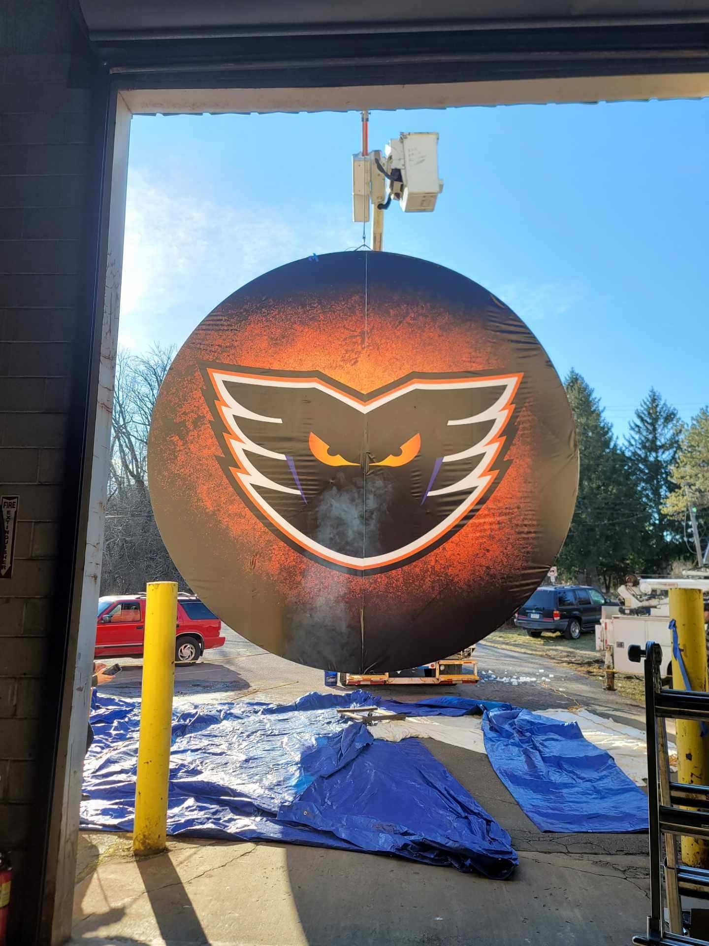 The hockey puck built by Richmond Machine & Welding is lifted outside of the building on Wednesday.