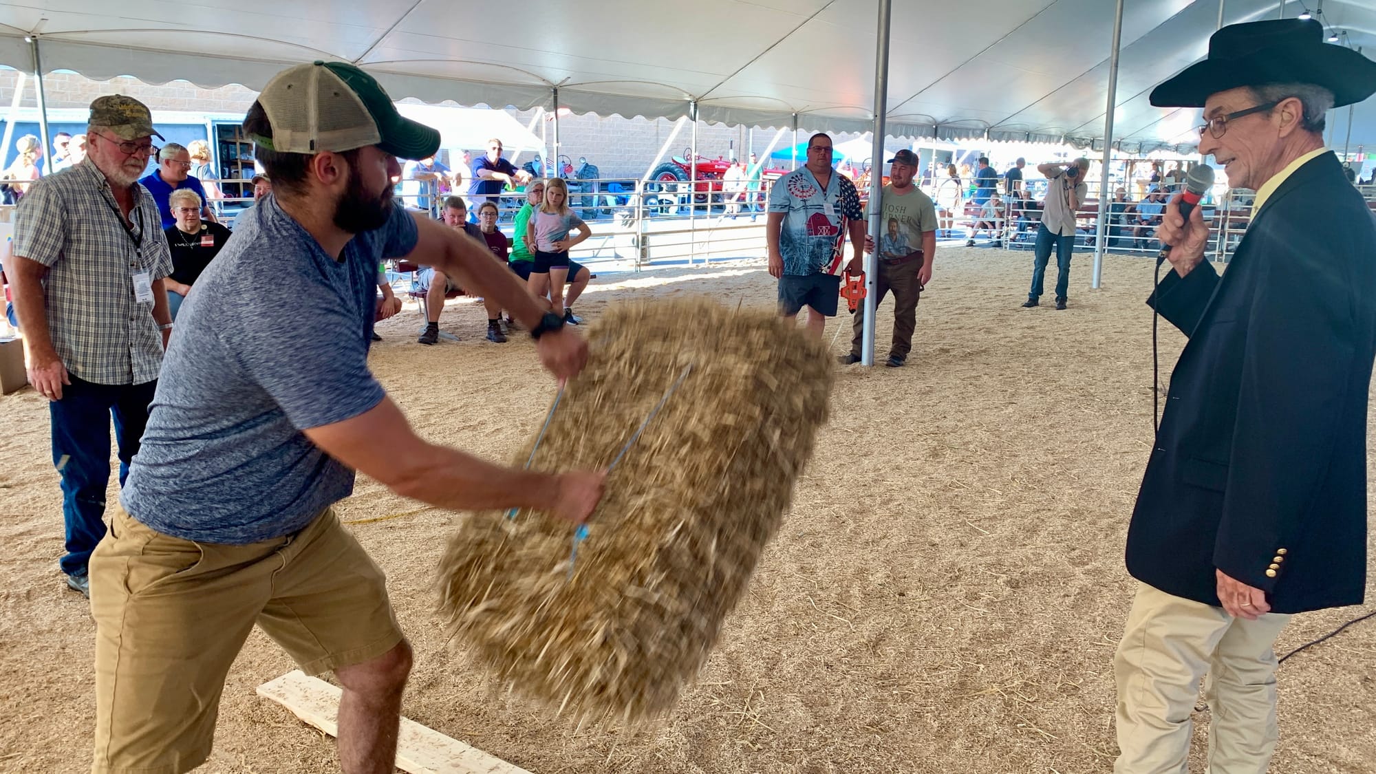 A competitor at the hay bale throwing competition at the Great Allentown Fair.