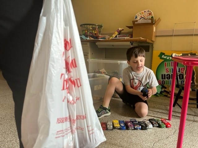 6-year-ol Peter plays with toys as his mom picks up a free lunch for him at Lehigh Valley Health Network’s 17th Street campus