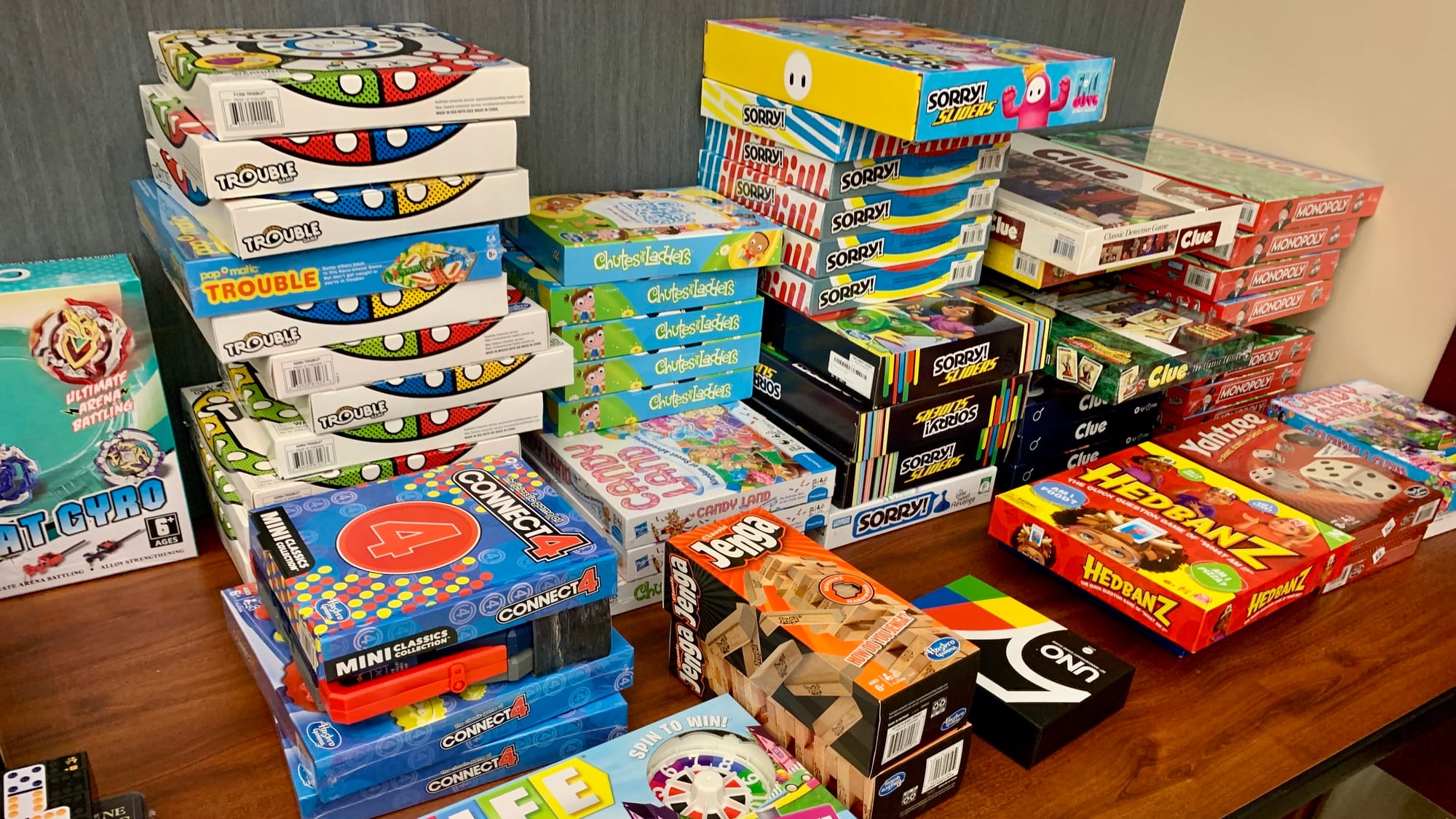 Stacks of donated board games for the KidsPeace Angel Tree holiday gift drive.
