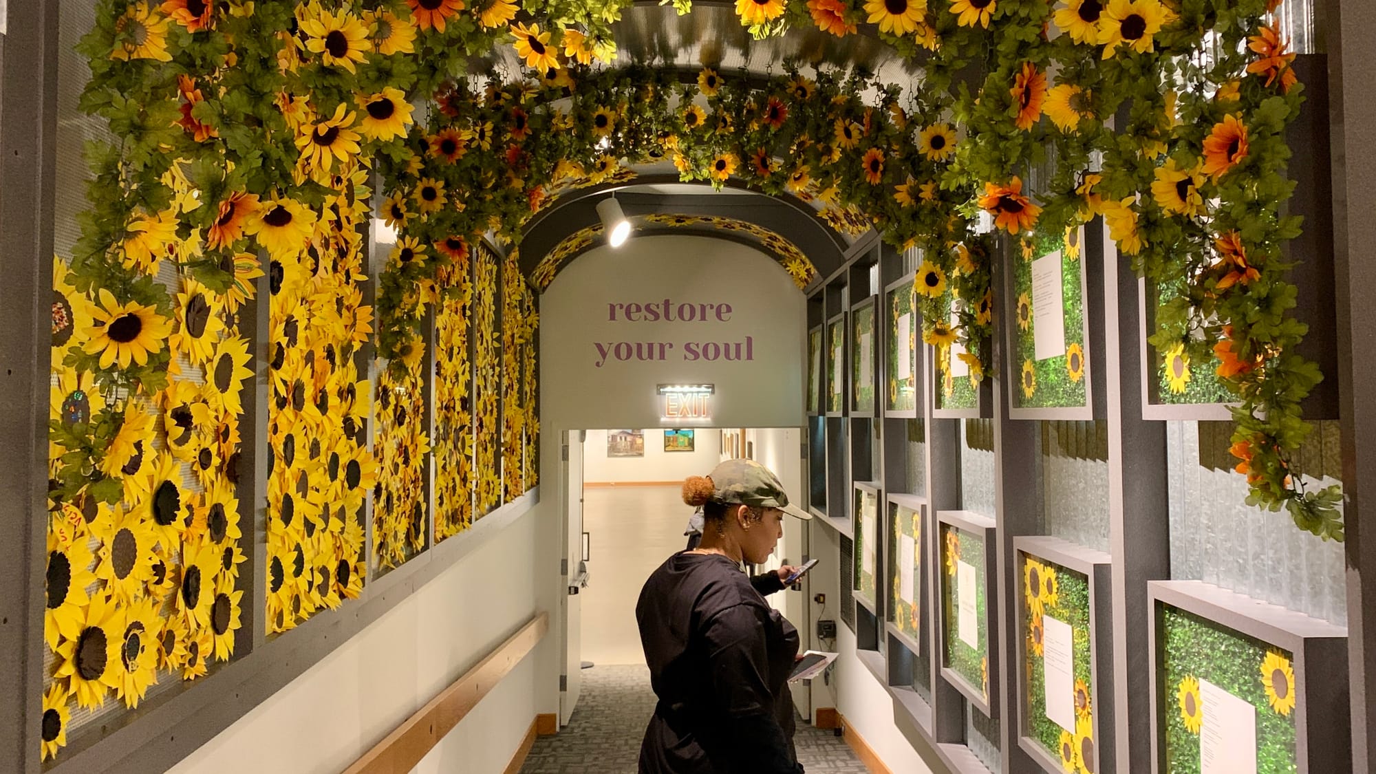 The entrance to the 'Restoring Petals' exhibition is decorated with paper sunflowers, which were made by about a thousand peo