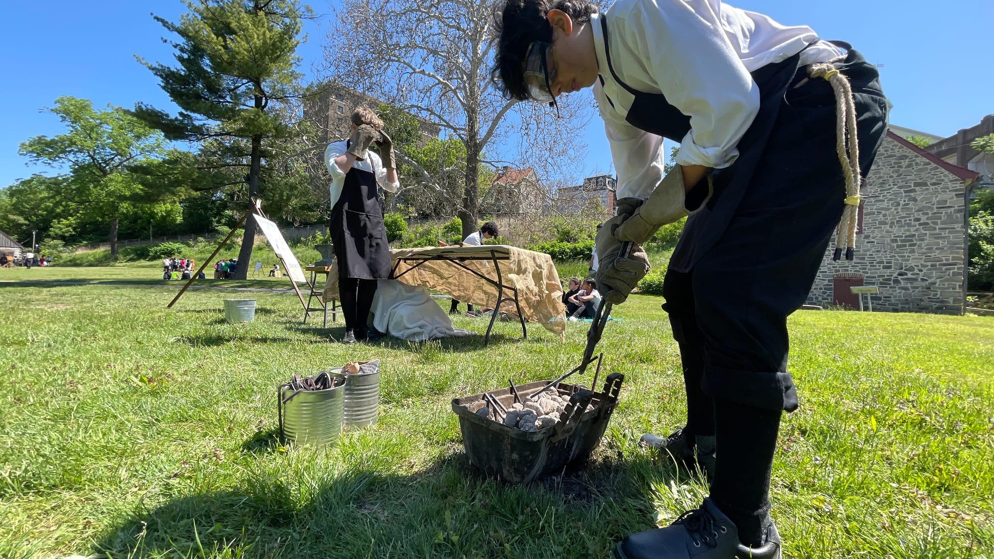 Heinz Schmitt, East Hills Middle School student, takes the steel piece off the heat and prepares it to be hammered into shape