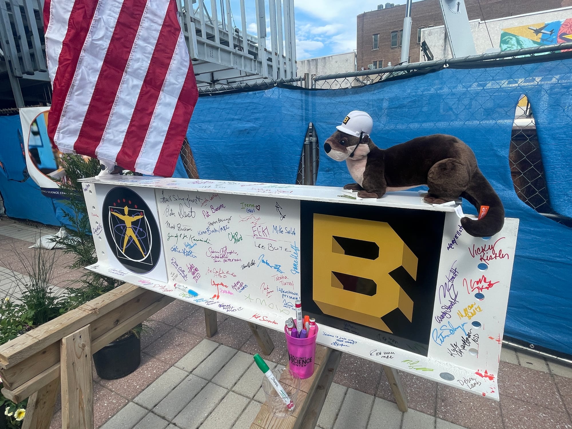 An otter, who some might say was the star of the show today, sits on the final steel beam. Officials with the Da Vinci Center