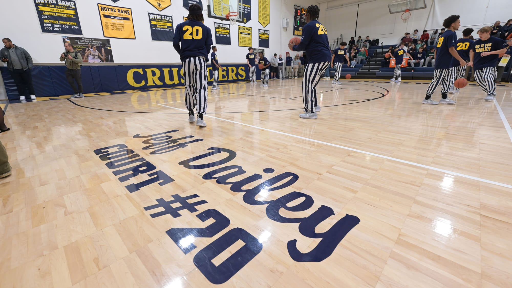 Players warm up before a court dedication for Jeff Dailey on Friday, December 1, 2023, at Notre Dame-Green Pond High School.