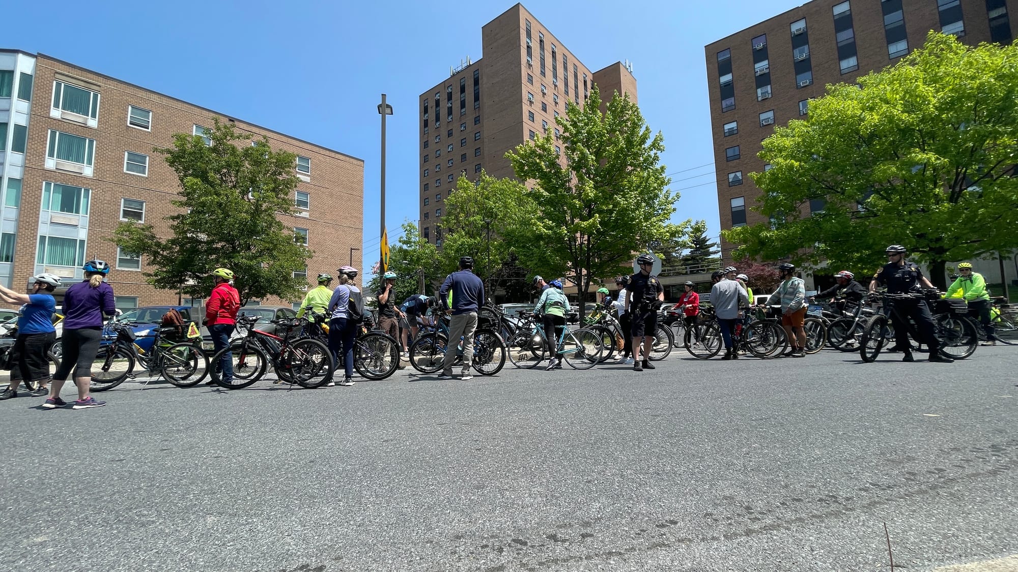 The group stops to chat while the the puncture is fixed on the mayor's bike.