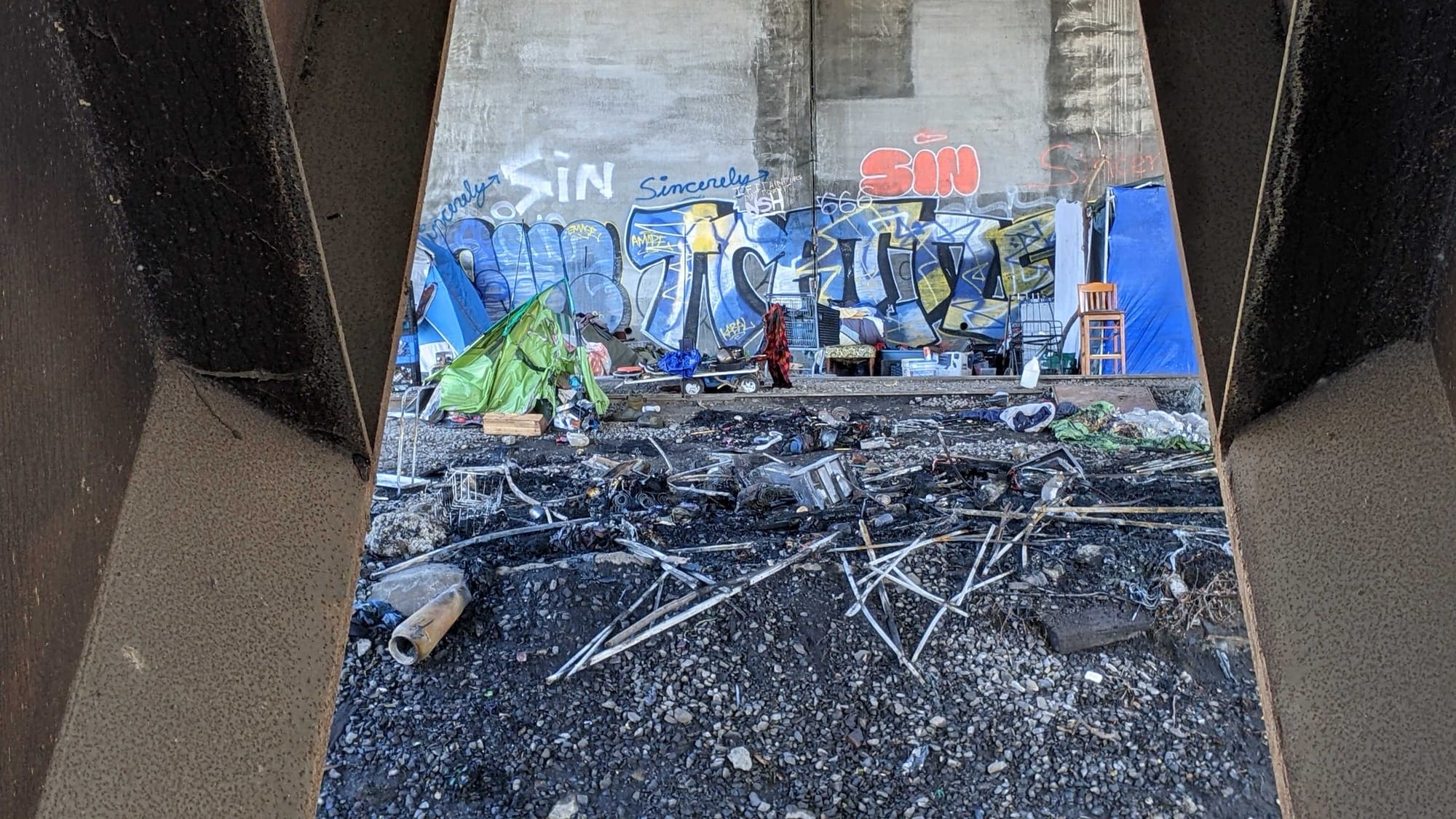 Police say two adult men were found with burns to their arms and hands following an early morning fire at an encampment under