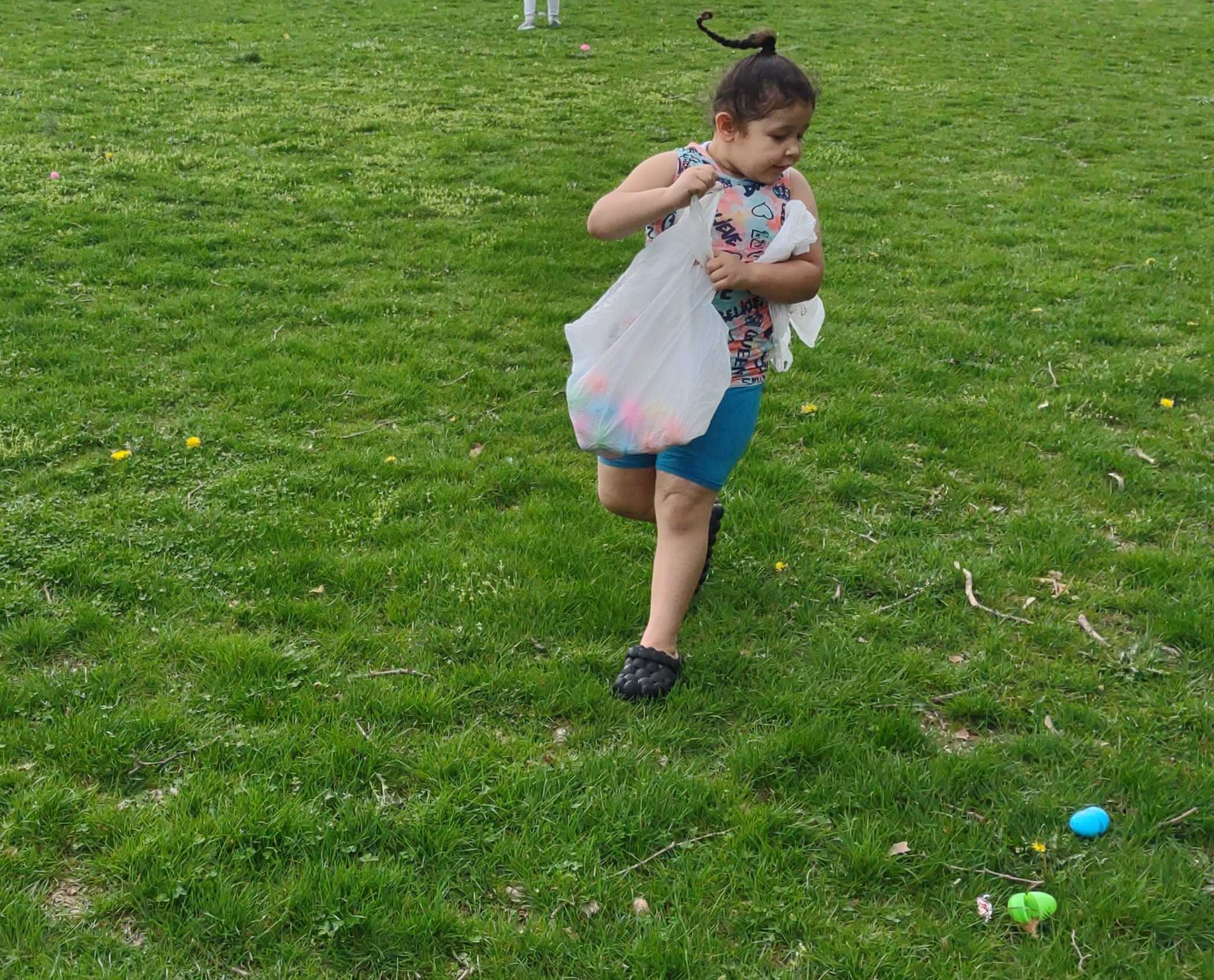 Mikaylah Burreto, 5, slams on the brakes as she spots eggs during the Mayor's Egg Hunt at Jordan Park in Allentown on Saturda