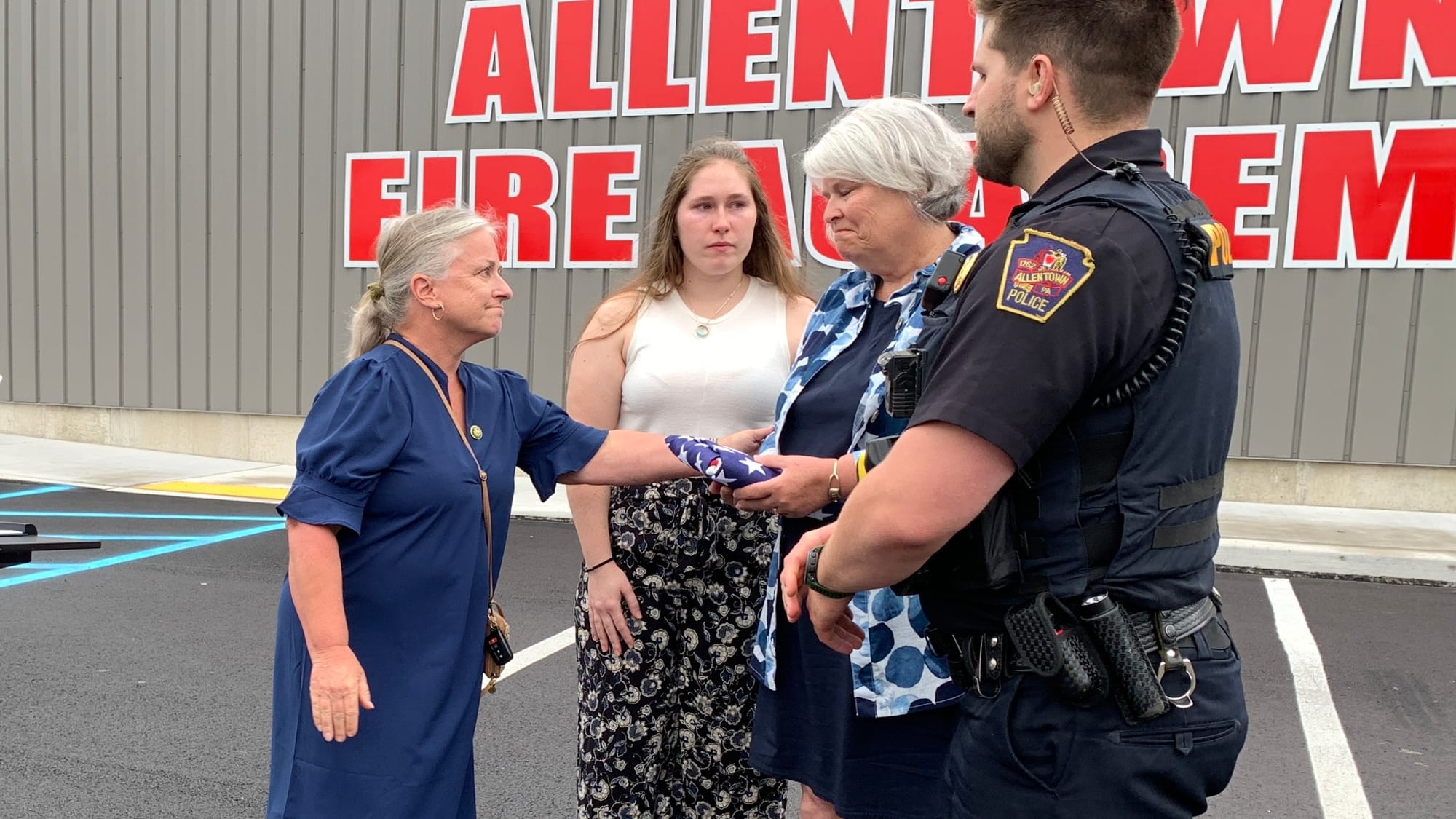 Rep. Susan Wild gives a flag that was flown at the U.S. capitol to Christopher Kiskeravage's family. His daughter Kathryn is 