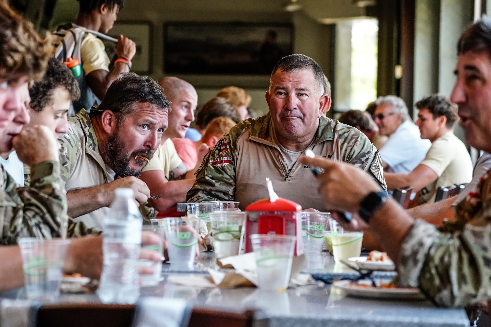 Shawn Tufts, left, and Marc Hogue, center, have lunch with Lehigh football players. U.S. Special Forces members including U.S