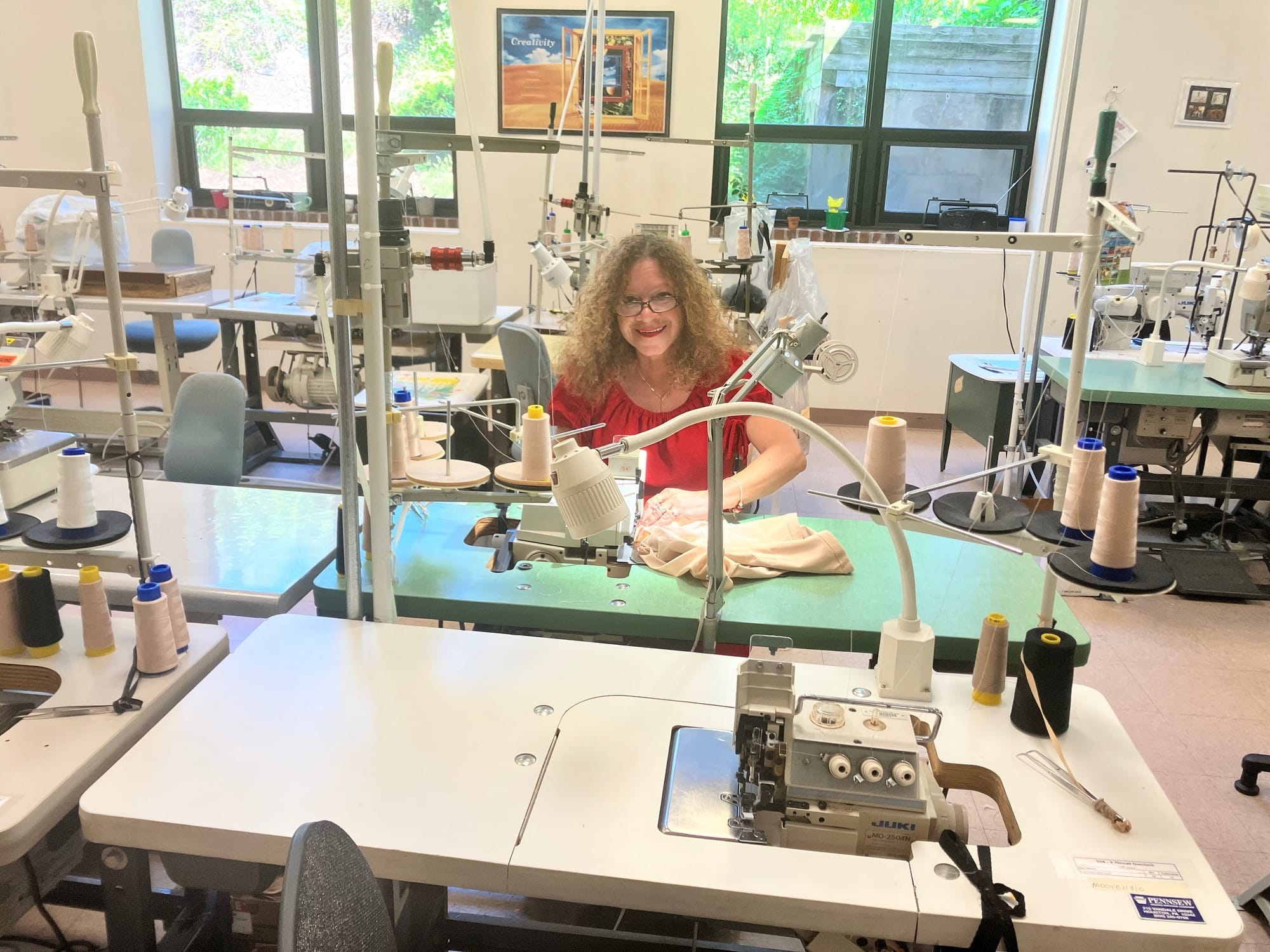 Sample maker Maritza sews pattern pieces together at Cupid Intimates design studio in Bethlehem.