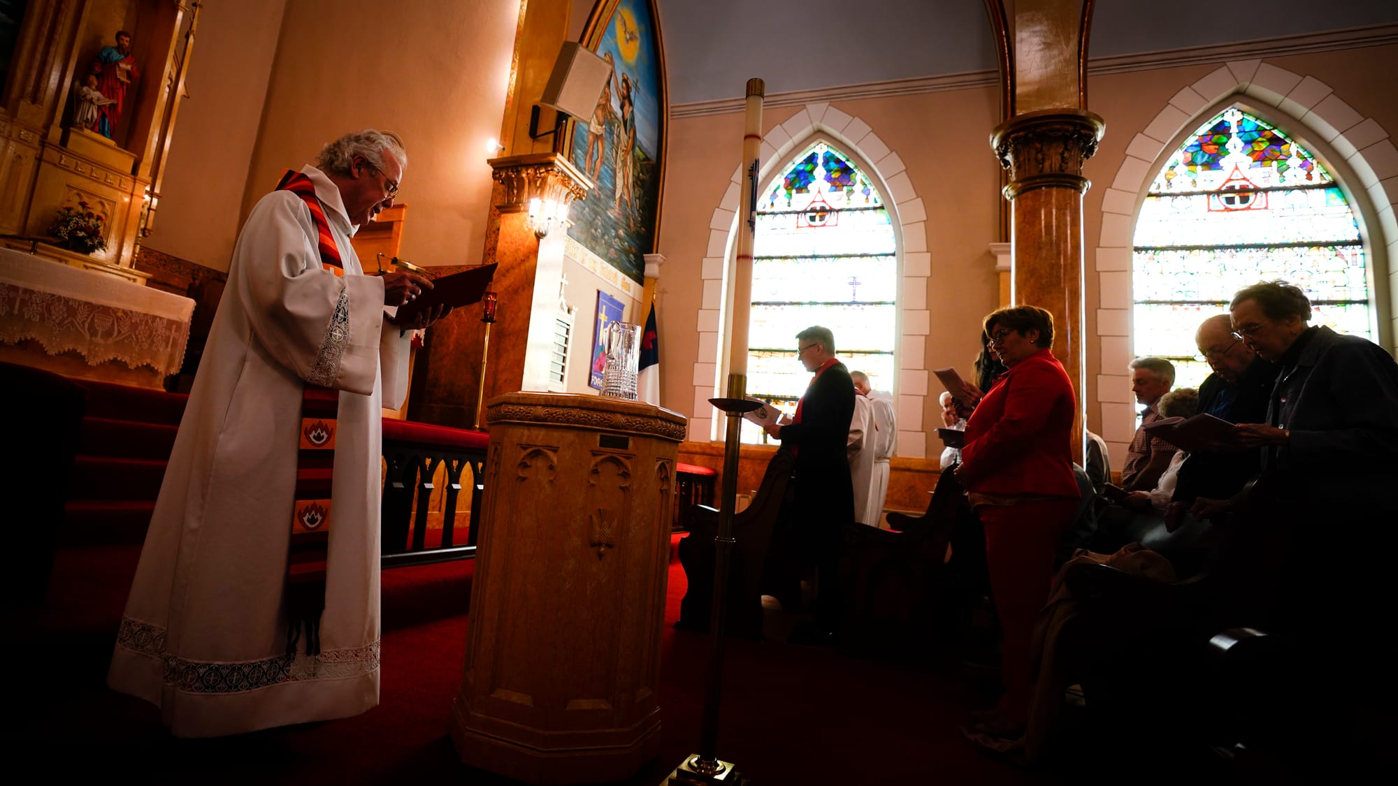 Rev. Mike Button, Interim Pastor, left, conducts service. A Thanksgiving and Leave-Taking service was held at St. John's Wind