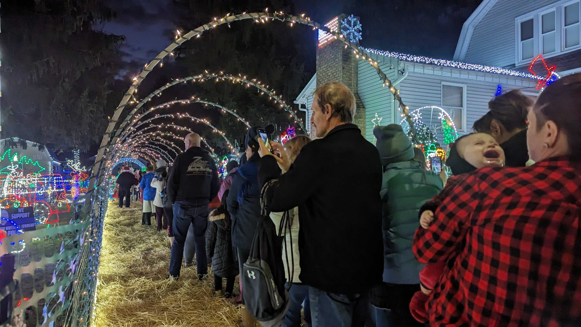 People wait in line to walk through the Lights in Greenawalds display on Saturday during Opening Night.