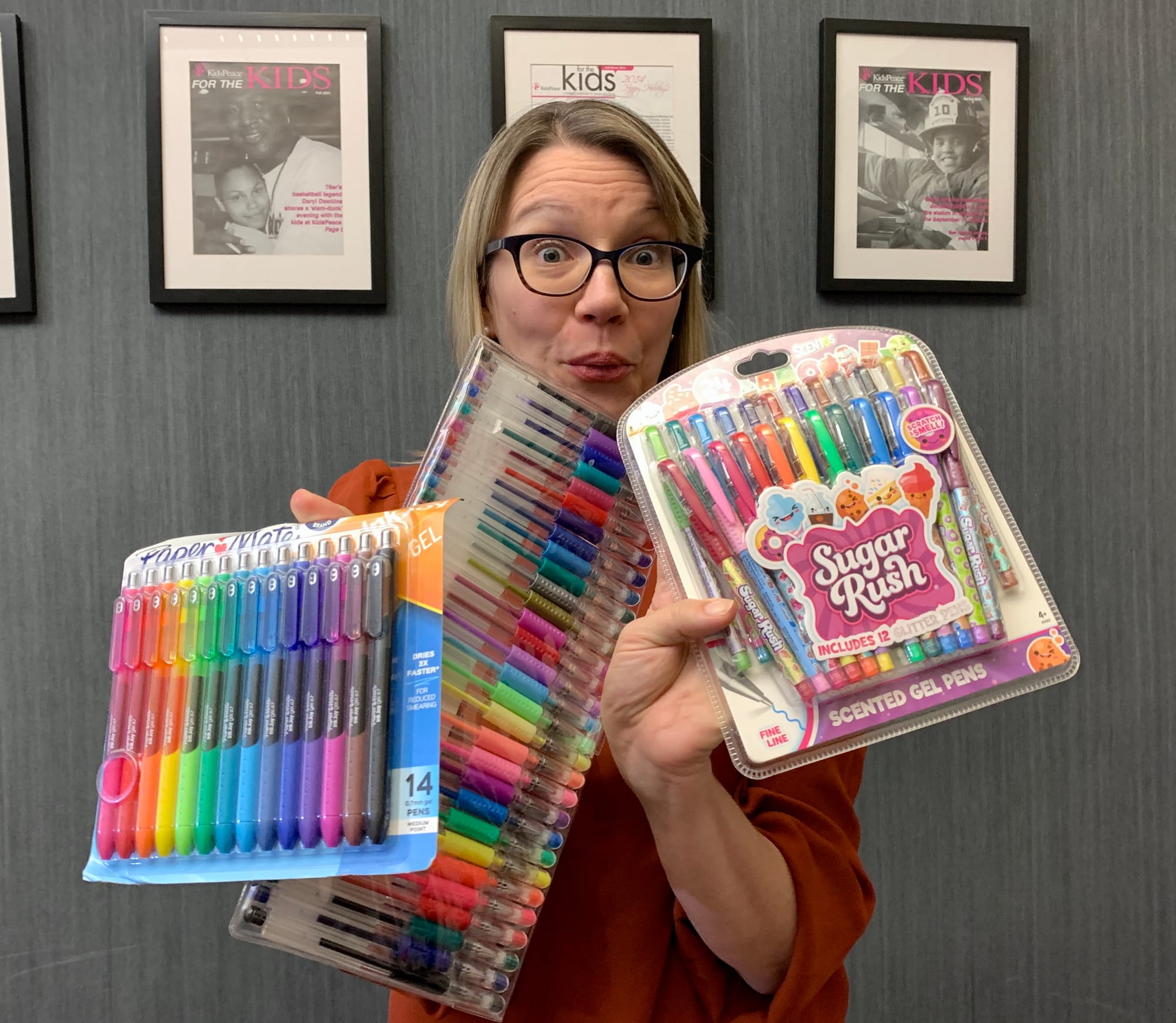 KidsPeace Director of Development Missy Hartney holds up gel pens, another top gift of 2022.