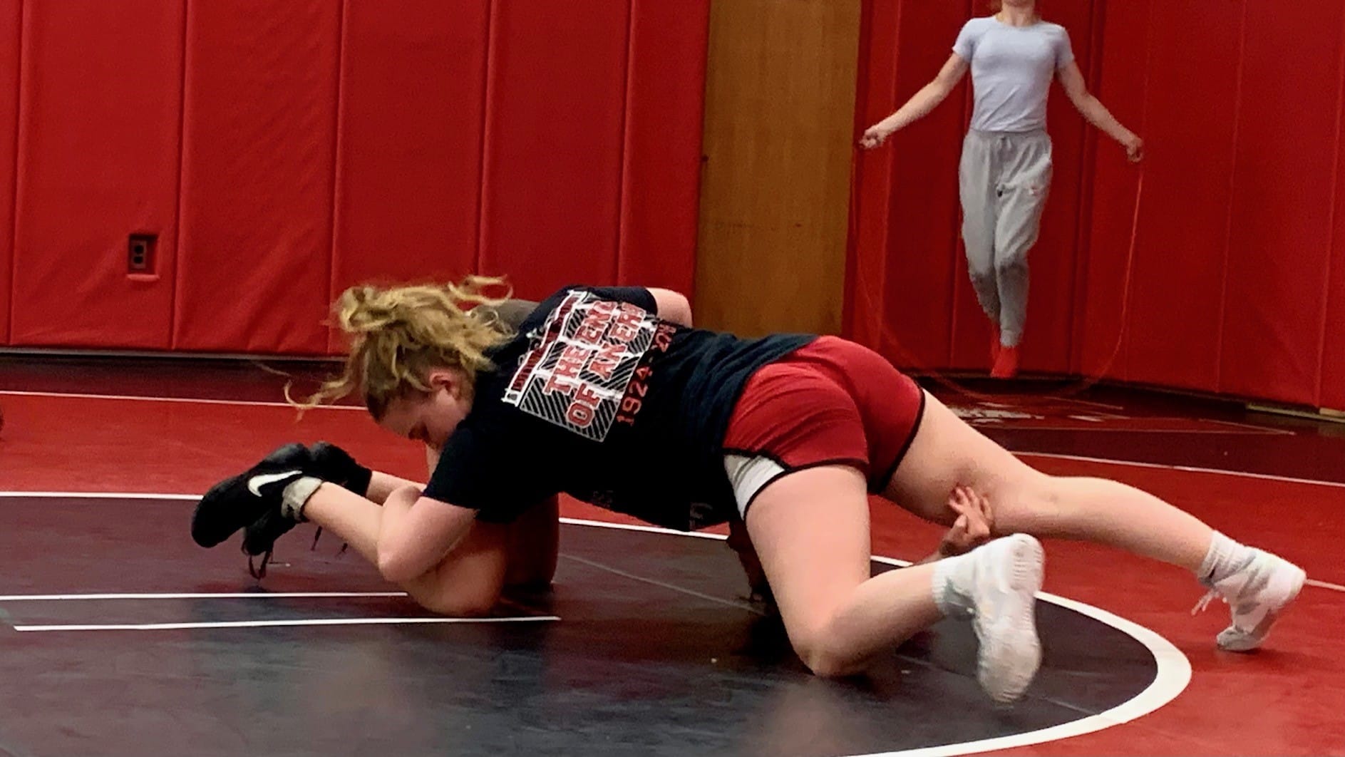 Eighth-grader Ruby Fairchild practices pinning her teammate during a practice on June 14th.