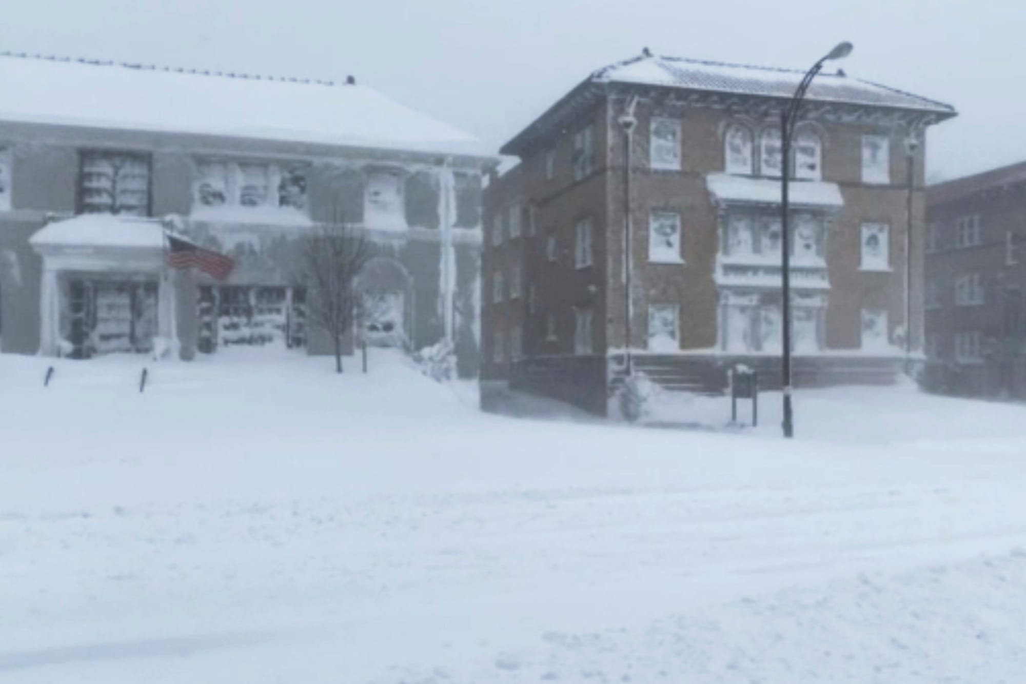 High winds and snow covers the streets and vehicles in Buffalo, N.Y. on Sunday, Dec. 25, 2022. Millions of people hunkered do