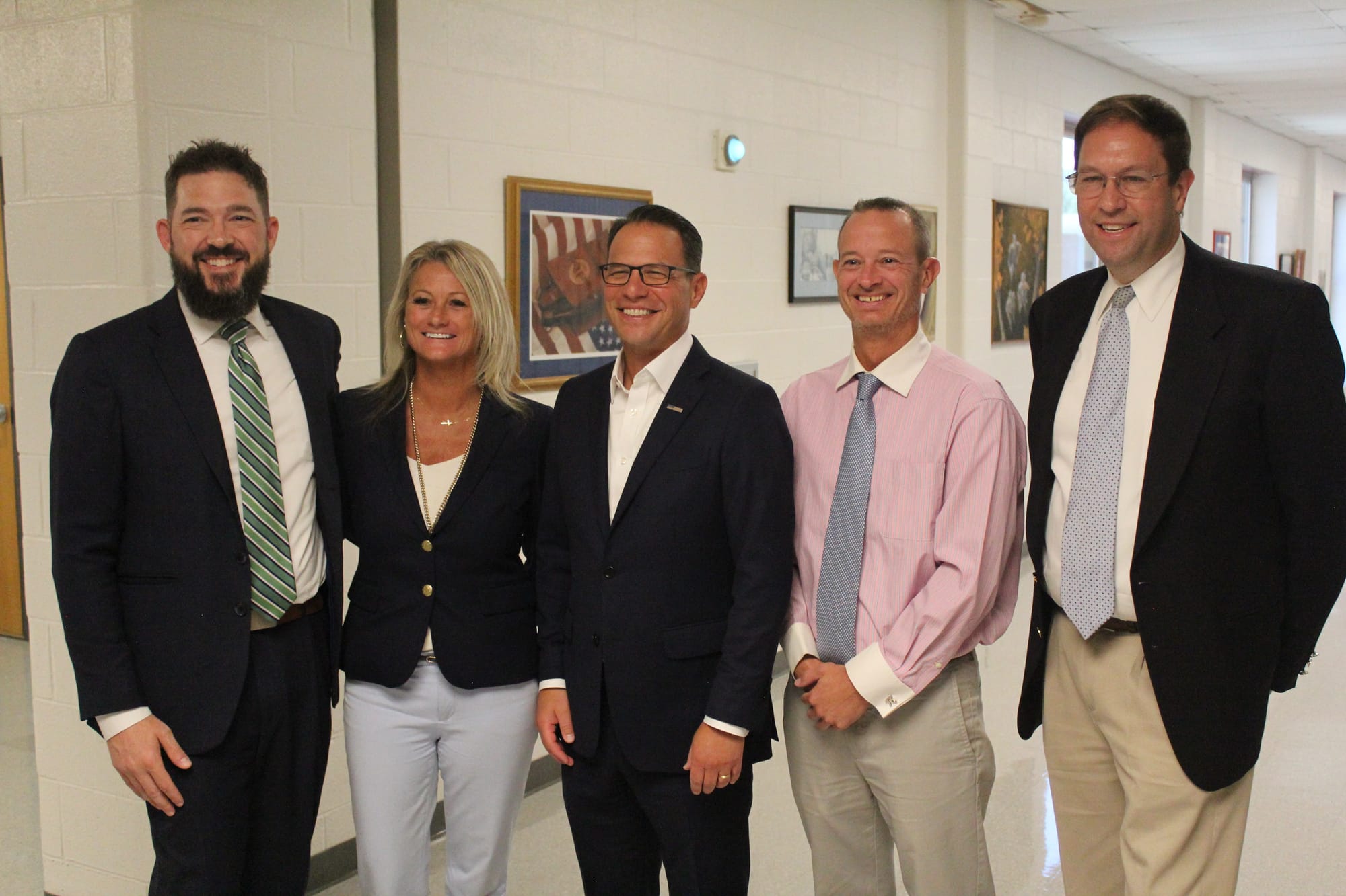 Governor Josh Shapiro (center) with school board members Adam Smith (far left), Josh Shapiro (far right), and East Penn Educa