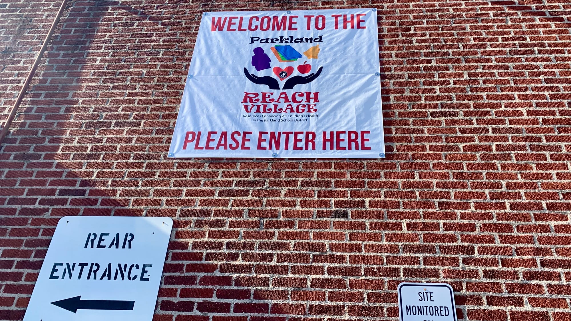 The sign for the Parkland REACH Village at the back of the Troxell Building.