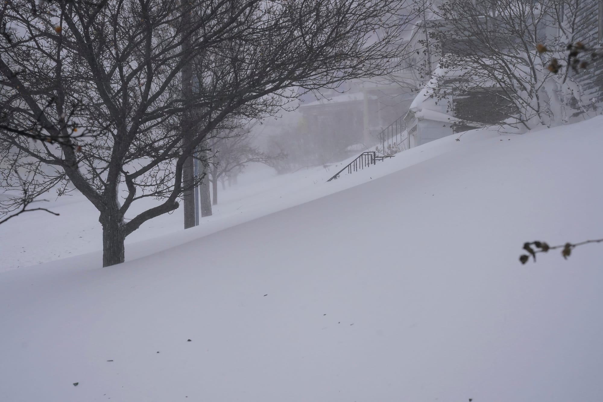 Snow drifts over the sidewalk on West Delavan Avenue in Buffalo, N.Y. on Saturday, Dec. 24, 2022. (Derek Gee/The Buffalo News