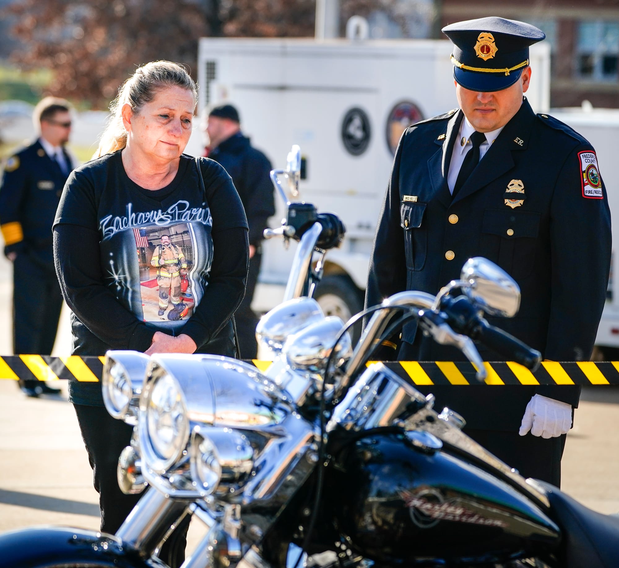 Carol Paris, mother of fallen New Tripoli firefighter Zachary Paris, left, looks at a display of her late son's things includ