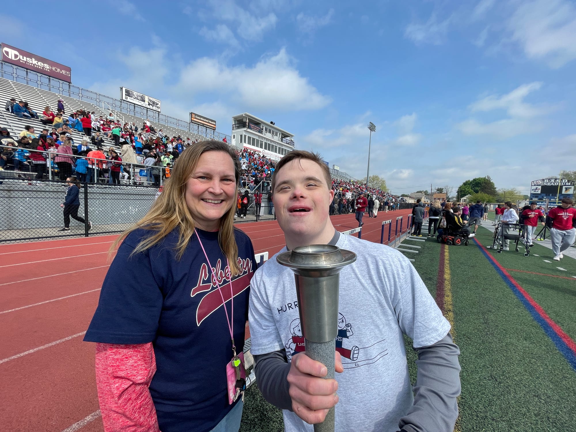 CJ holds the torch after doing the ceremonial torch run, starting the games.