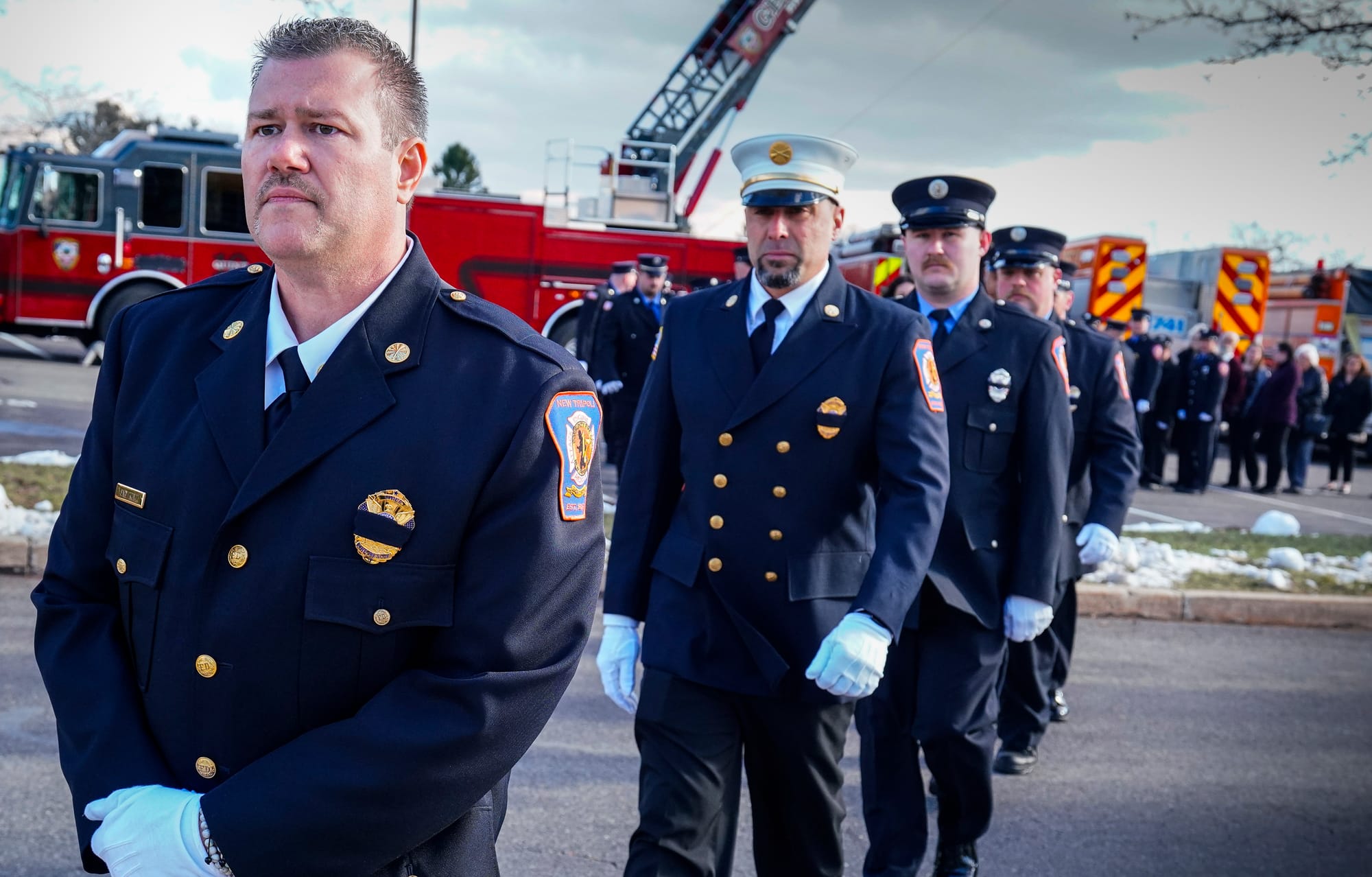 New Tripoli Fire Chief Gary Kuntz, Jr., left, leads New Tripoli firefighters into Saturday's ceremony. Mourners gather at Nor