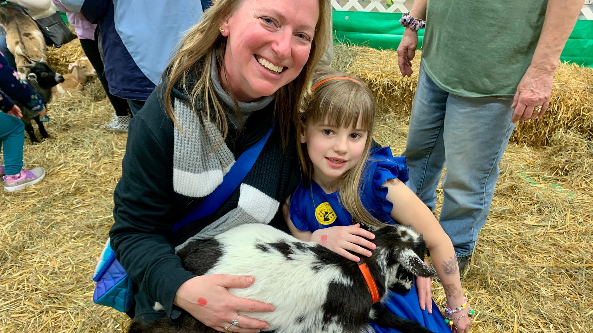 Attendees Julie Williams and Caroline snuggle a goat at the Steinmetz Family Farm's Baby Goat Snuggling.