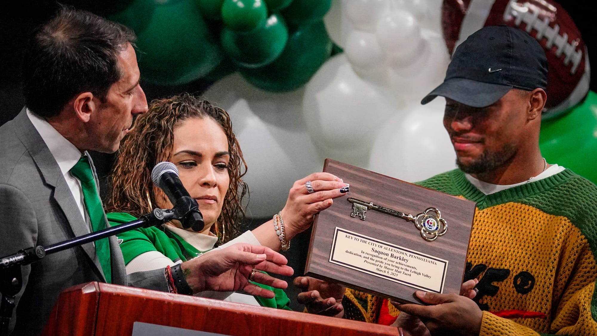 Allentown Mayor Matt Tuerk and special event manager Priscilla Reyes present a key to the city to Barkley. A Lehigh Valley ce