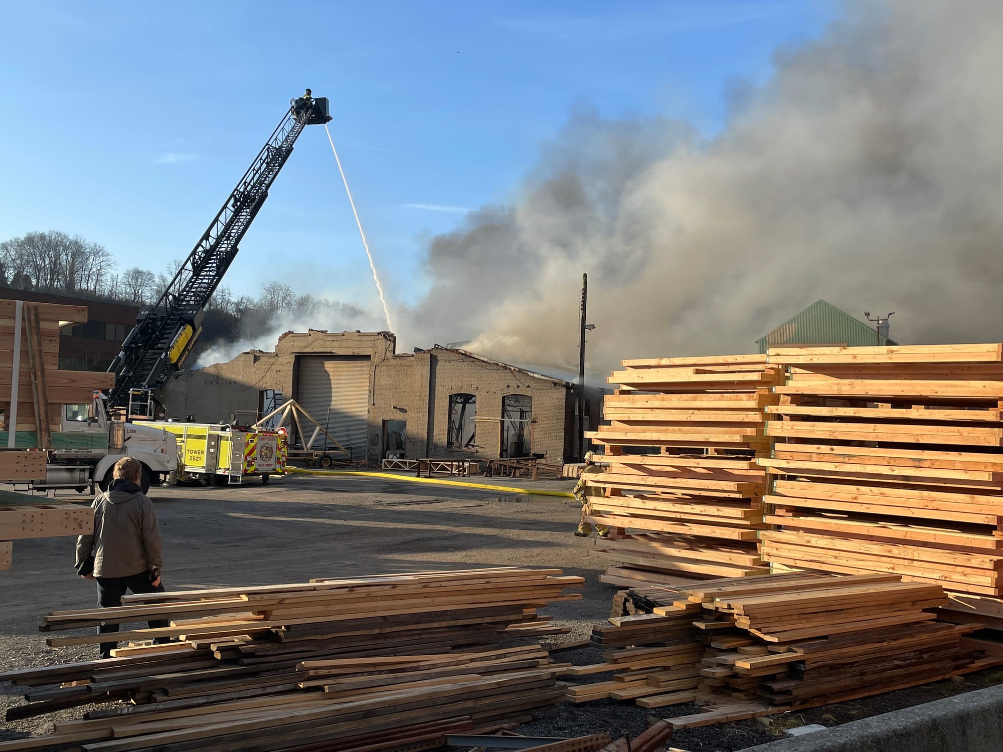 Firefighters pour smoke on a heavily damaged building in West Easton early Tuesday.